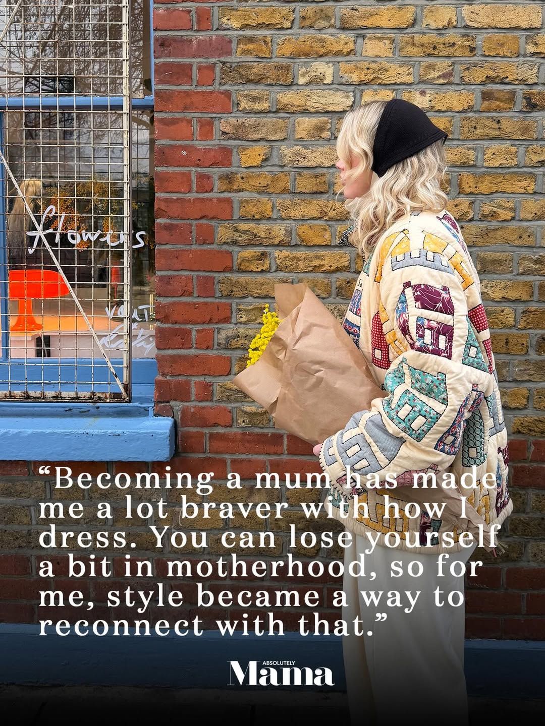 Woman in colorful patchwork coat holding flowers with motherhood style quote overlay by Mama magazine.