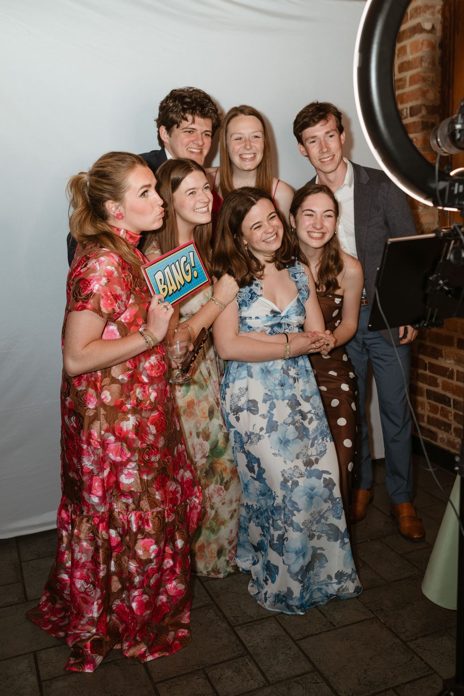 Group of wedding guests posing at a photobooth.