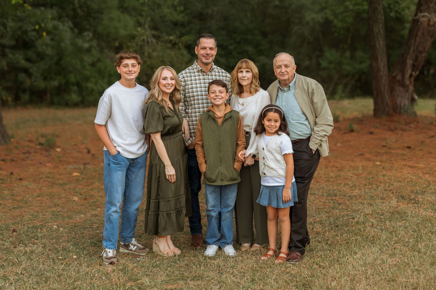 A beautiful extended family portrait in the woods. Includes kids, parents, and grandparents.