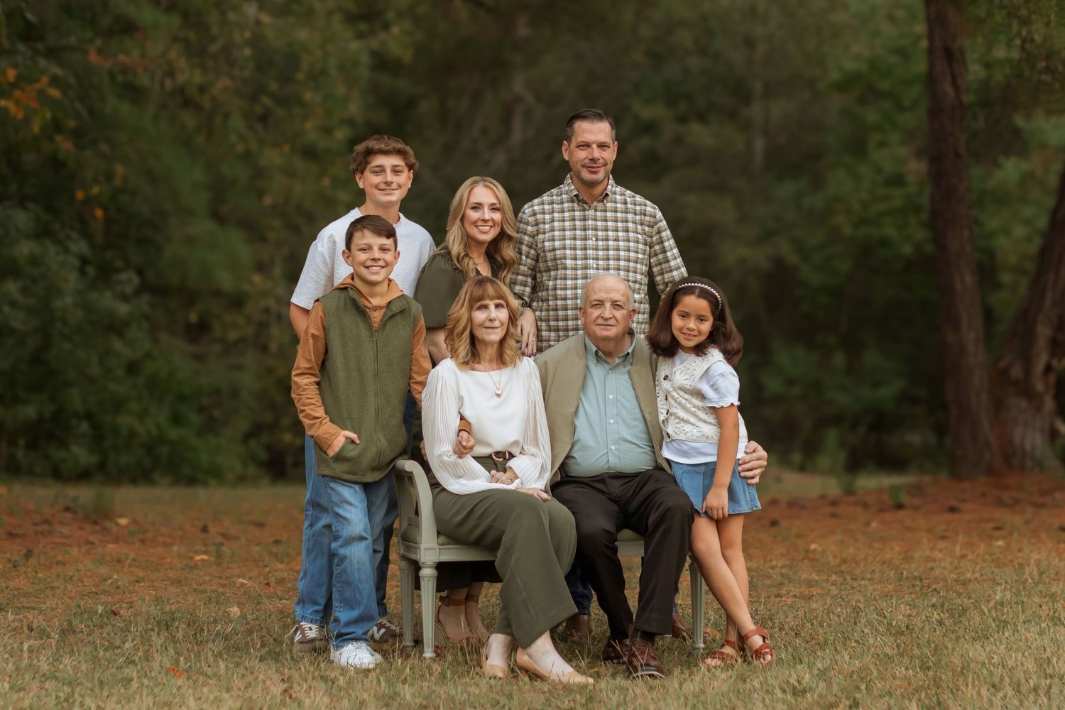 A beautiful extended family portrait in the woods. Includes kids, parents, and grandparents.
