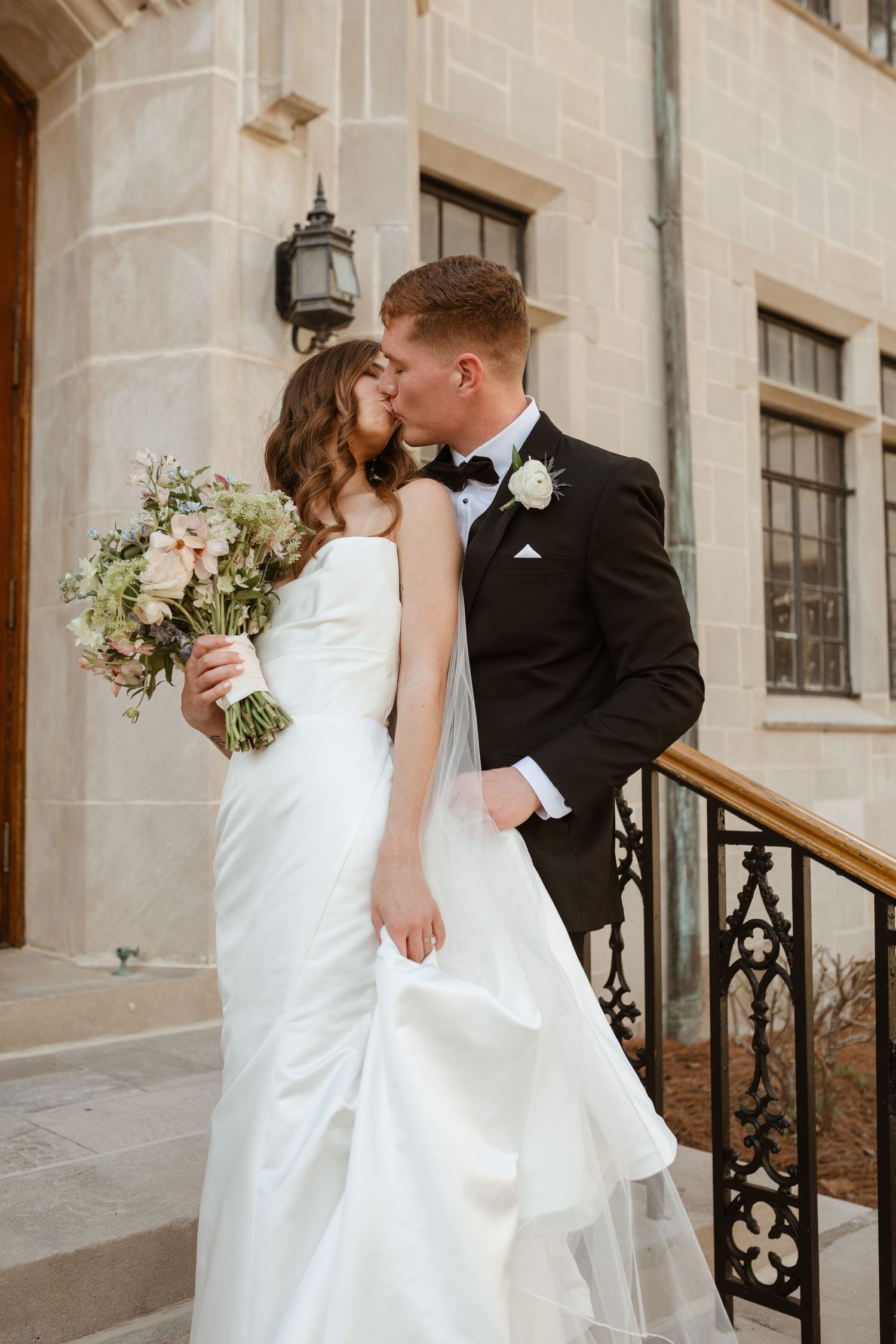 Bride and groom kissing on wedding day.