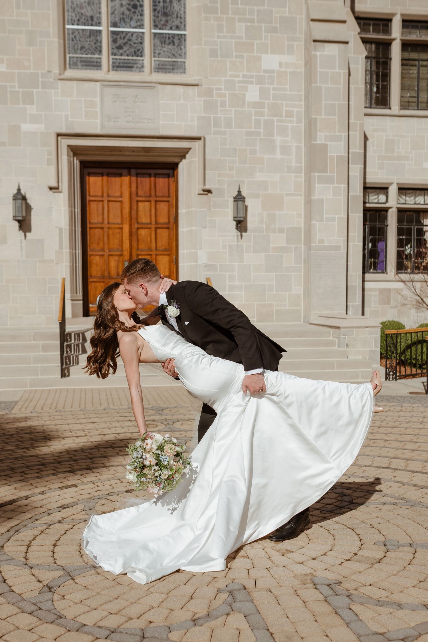 Bride and groom kissing on wedding day.