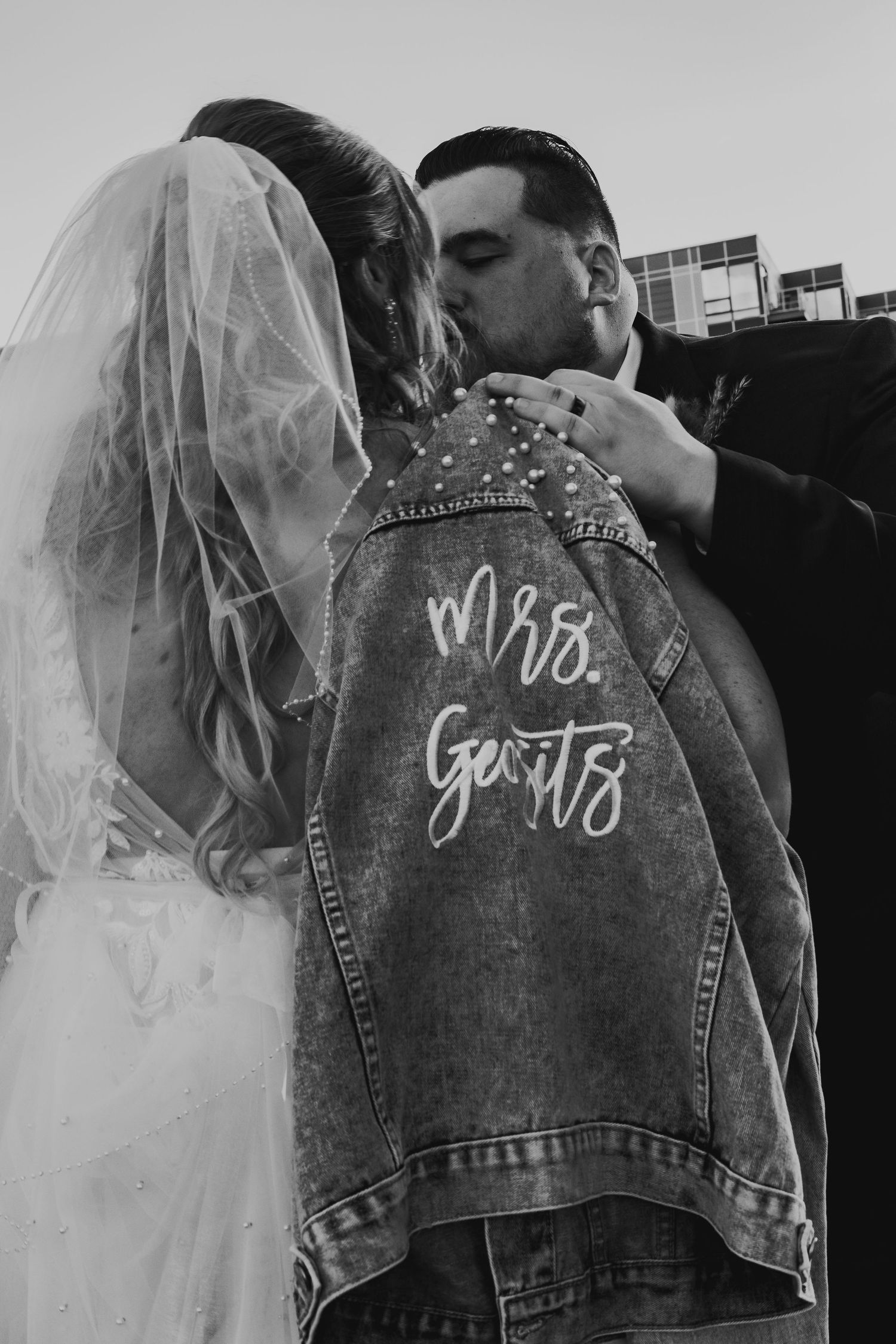 Couple embracing under string lights in Bethlehem PA, artistic documentary night photo
