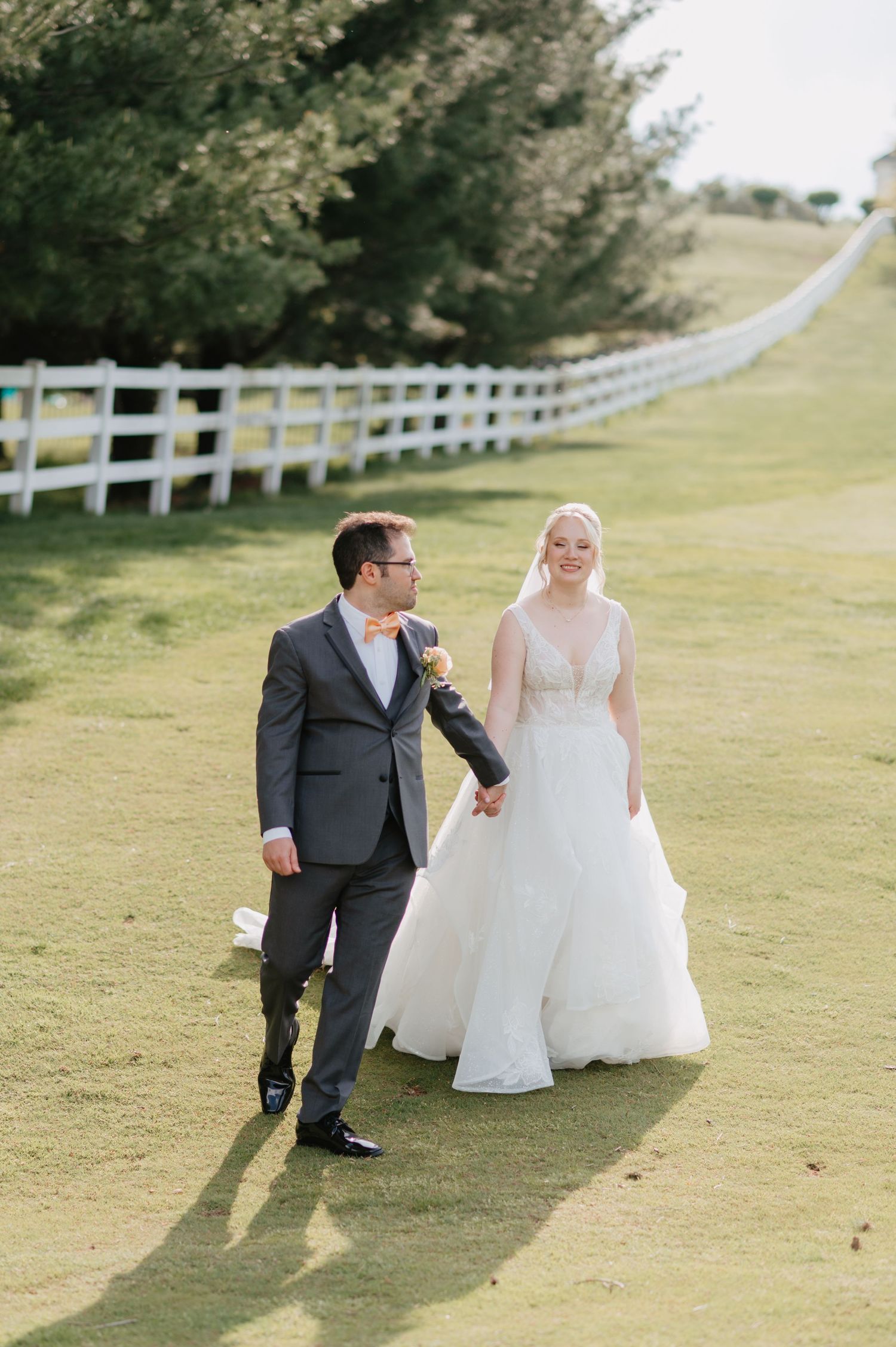 Ceremony kiss under blooming florals at The View At Morgan Hill. Wedding Photography bright and romantic wedding photo.