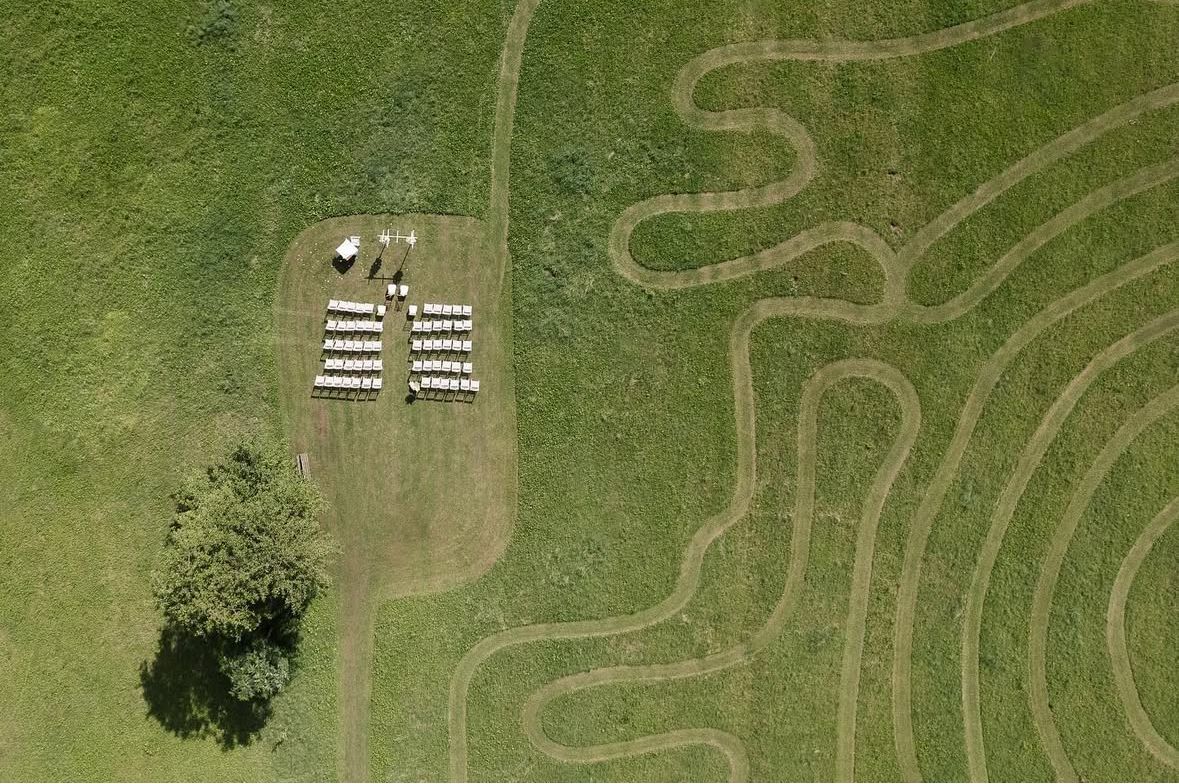 Aerial view of winding paths and patterns in a lush green landscape.