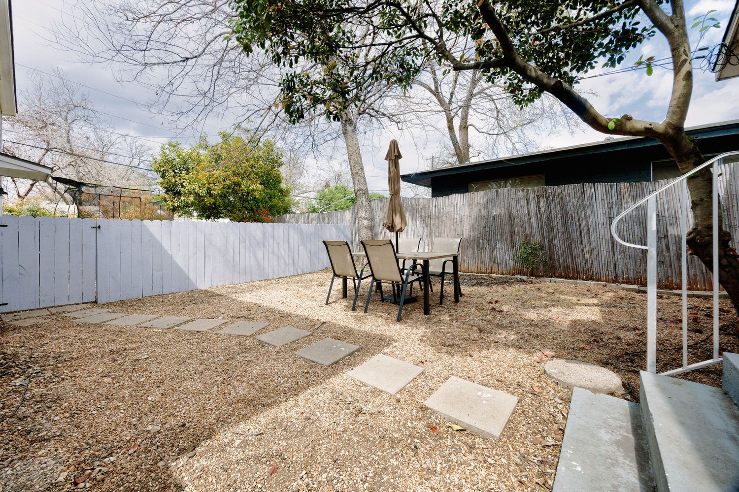 A series of landscape photos showing a backyard transformation with dirt, fencing, and outdoor furniture installations.