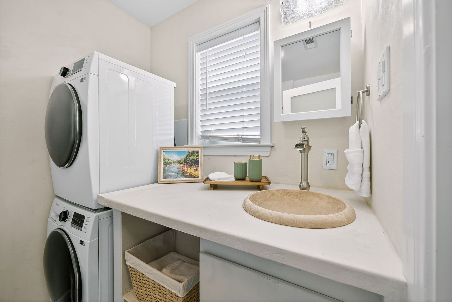 Modern white bathroom with floating vanity, vessel sink, and large mirror featuring neutral color scheme and natural light.
