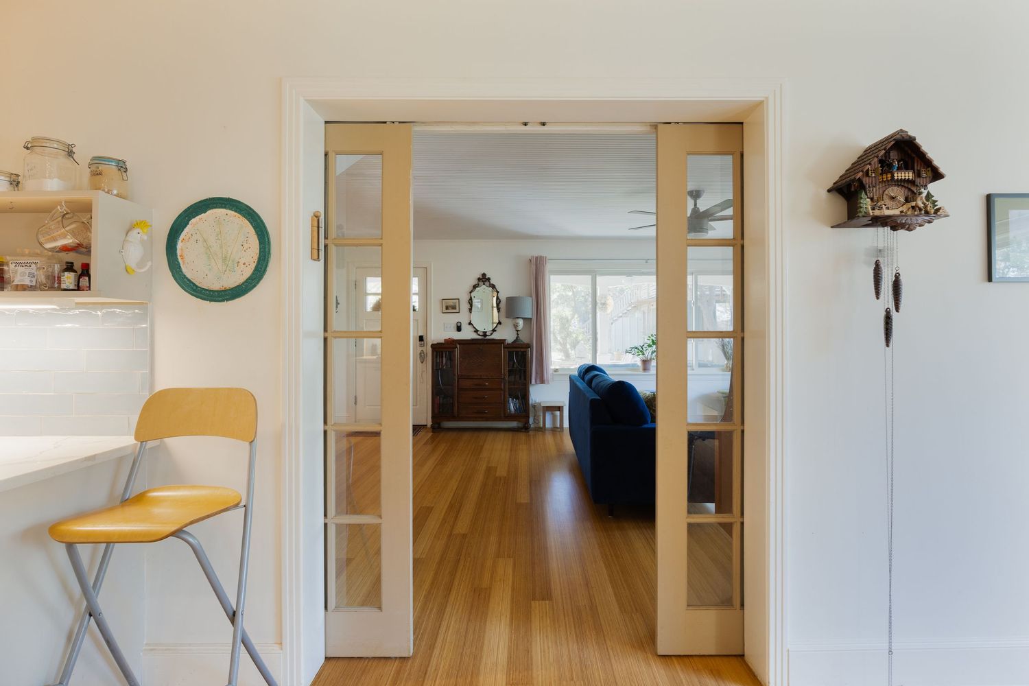 Long hallway view with sliding glass doors and built-in storage solutions.
