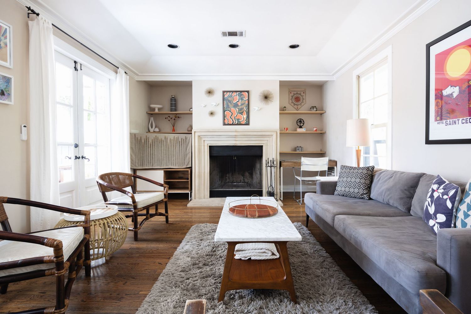 Contemporary open floor plan living space with gray sofa, area rug, and modern decor.