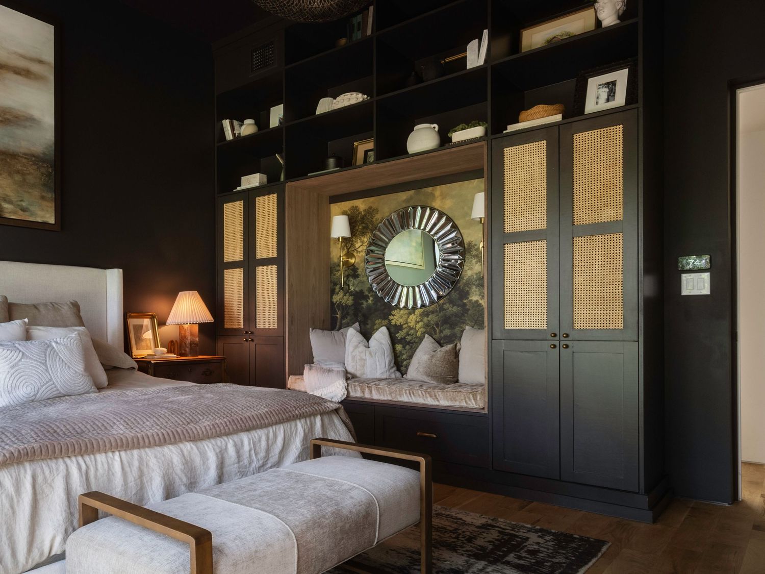 Modern bedroom with dark accent wall, built-in storage, and natural lighting.