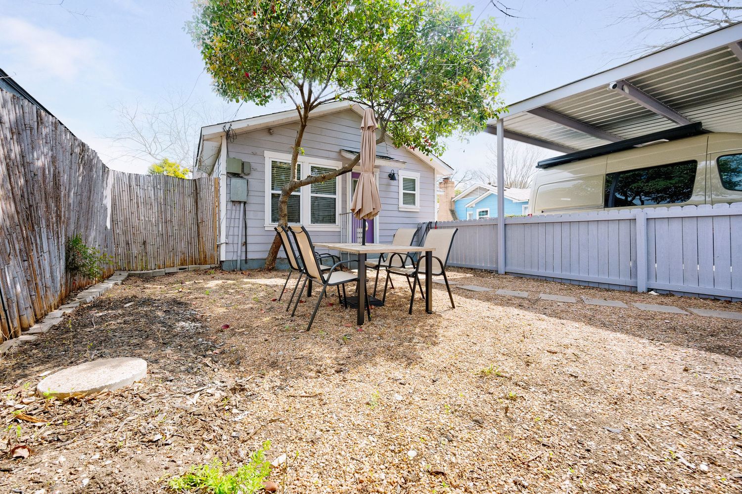 Multiple views of a dirt backyard with wooden fences and scattered debris showing different angles of the property.