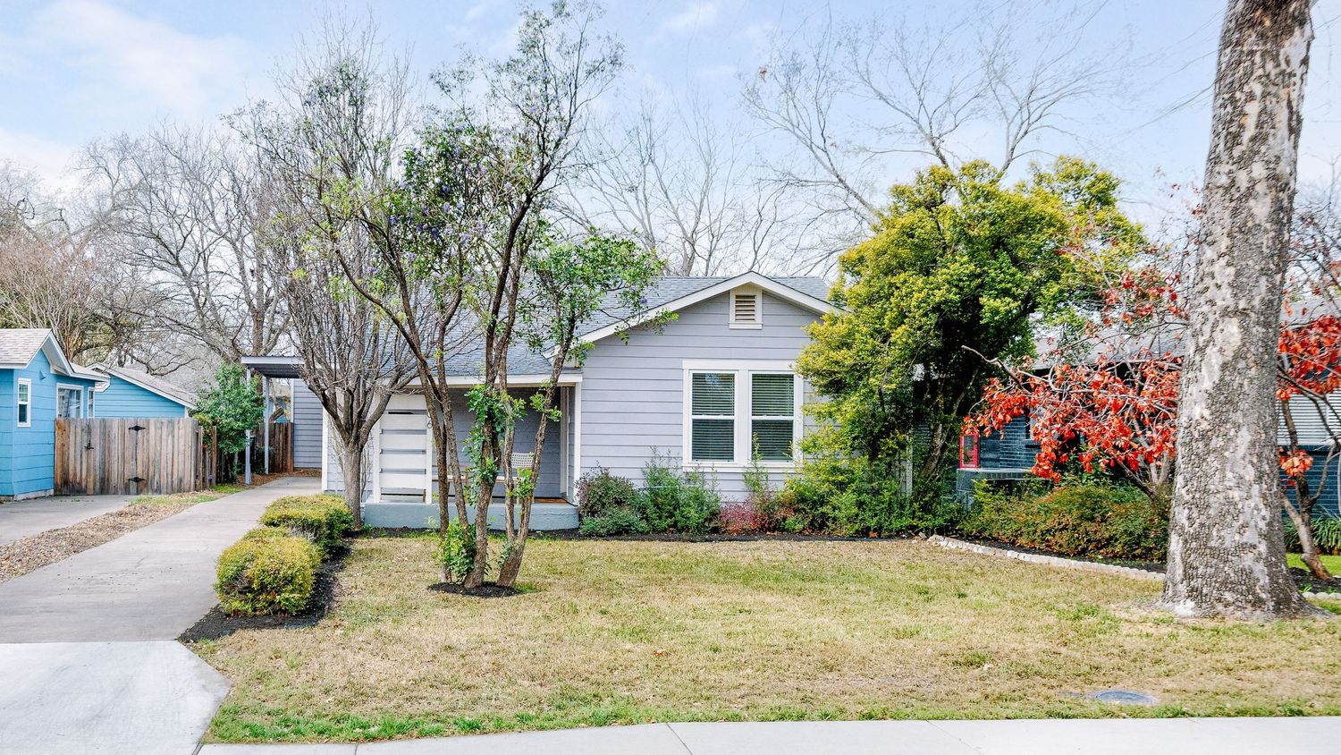 Four panoramic landscape images showing residential homes and yards with trees and grass in different seasons.