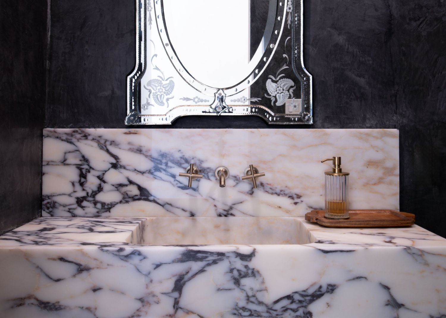 Luxurious marble bathroom counter with brass fixtures and decorative accessories.