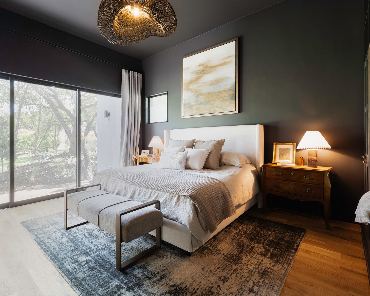 Modern bedroom with dark walls, large windows, and contemporary furnishings.