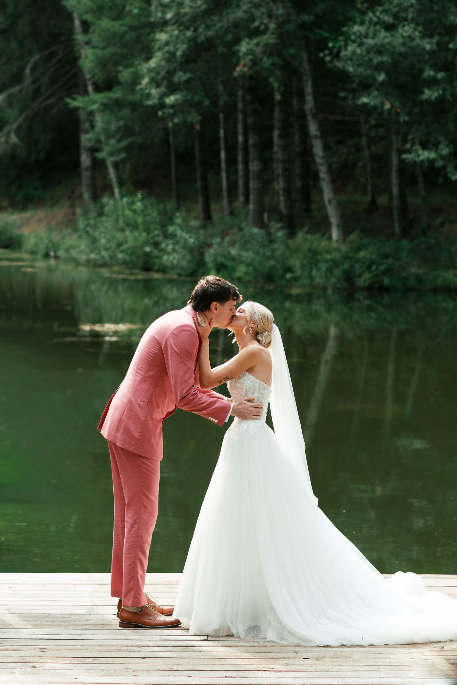 Wedding ceremony on a wooden dock by a serene lake - Adrianna Elizabeth Photography.
