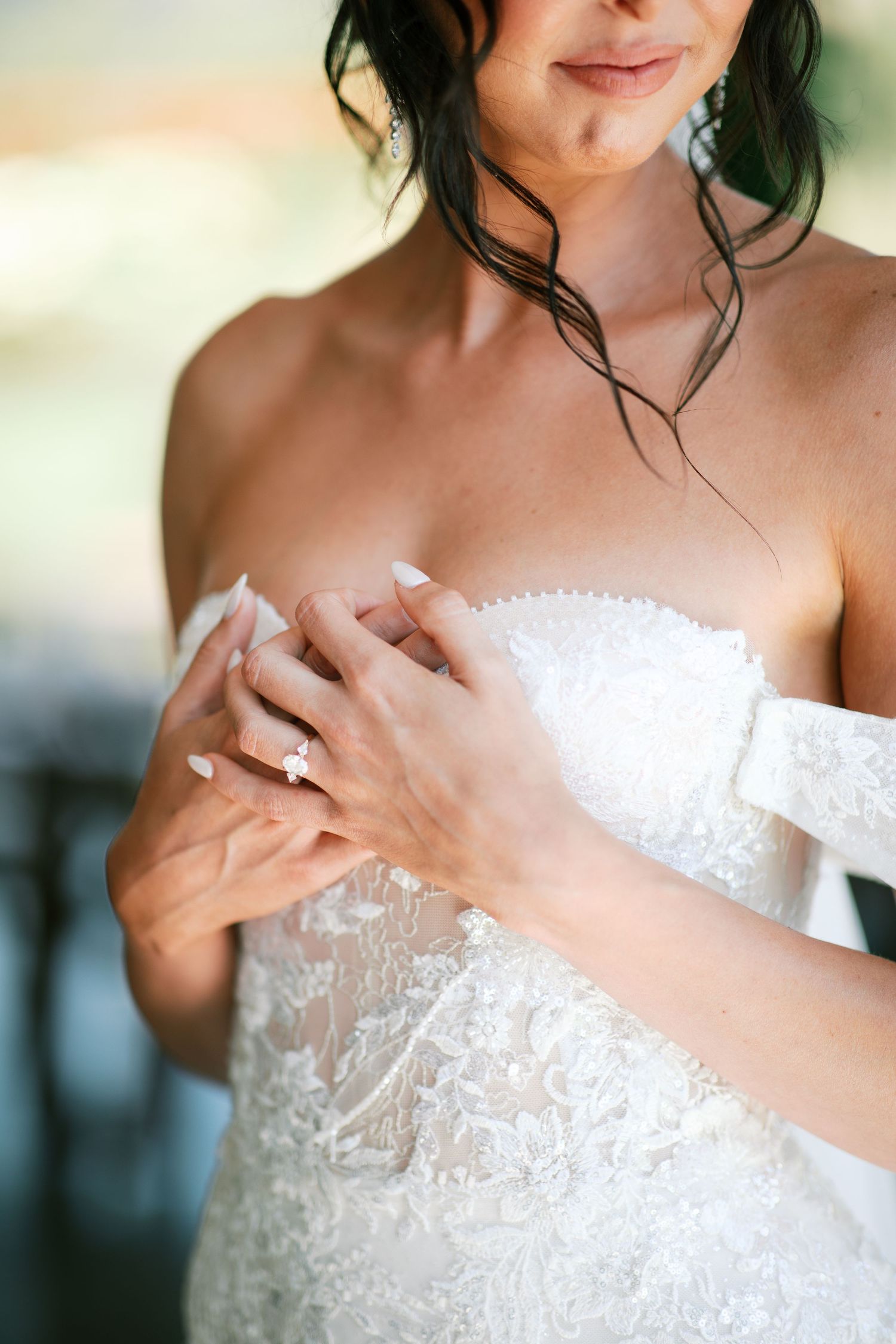 Close-up detail shots of a white lace strapless wedding dress bodice with delicate beading and embellishments.