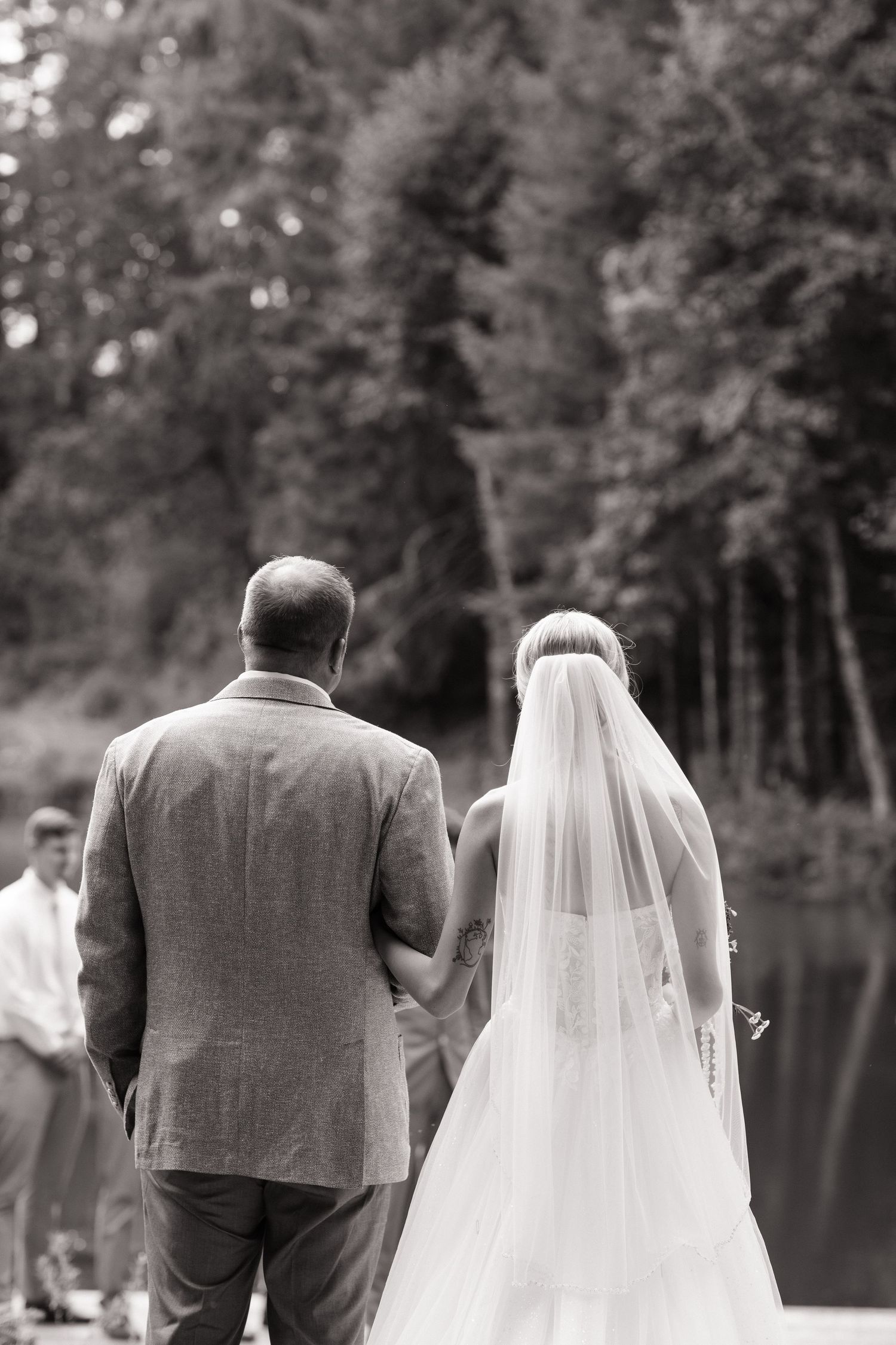 Black and white photo of the brides' father giving her away at the altar at an outdoor wedding ceremony-Adrianna Elizabeth Photography.