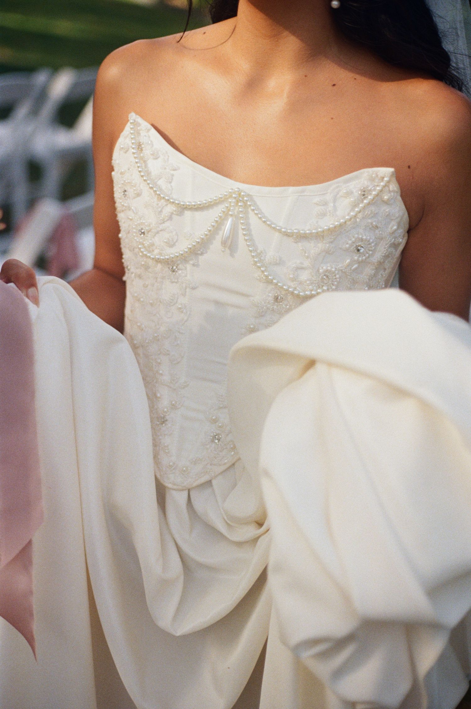 A series of close-up detail shots showing the delicate pearl beading and bow embellishments on a white wedding dress.