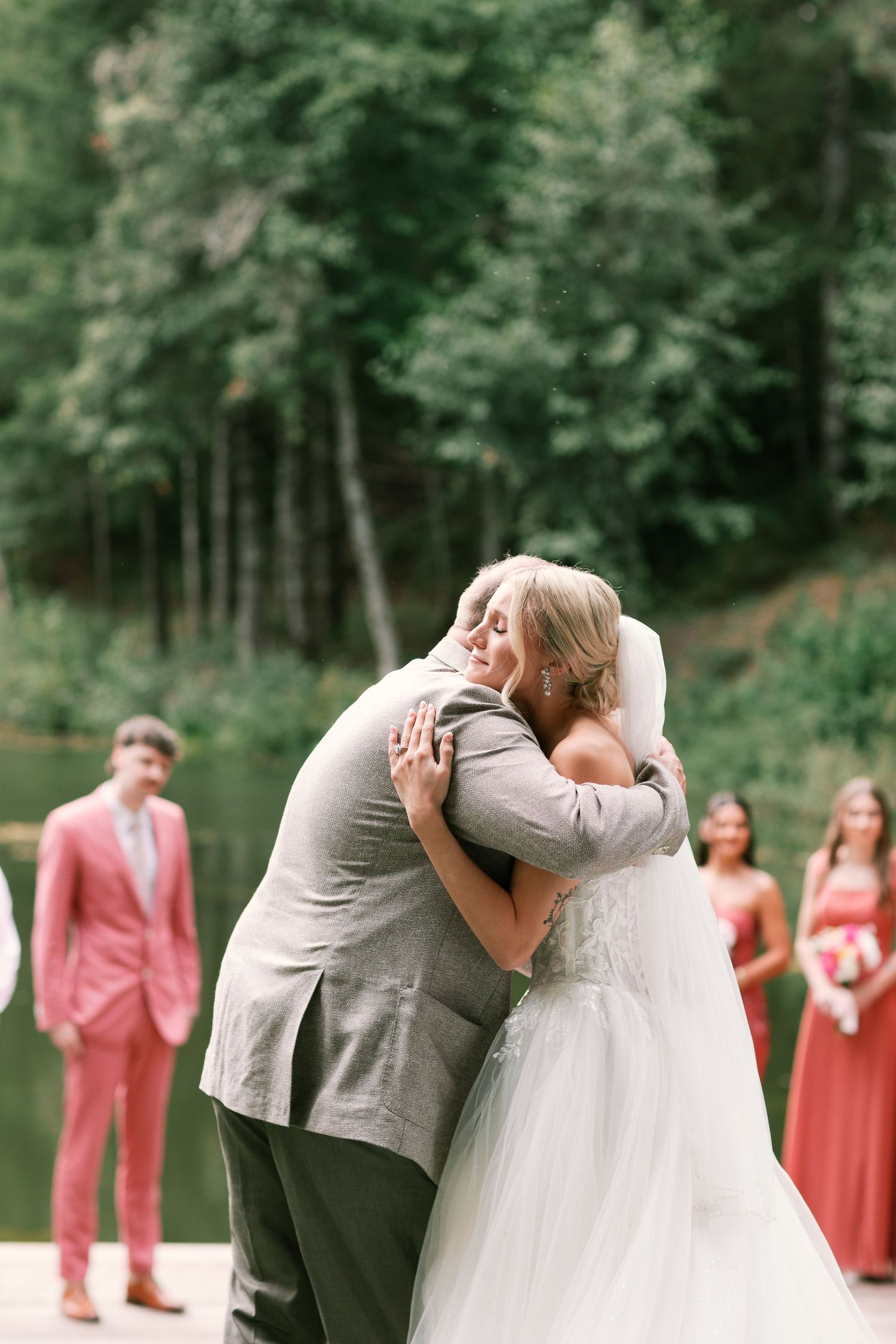 Bride and her father embrace before wedding ceremony on lakeside dock-Adrianna Elizabeth Photography.