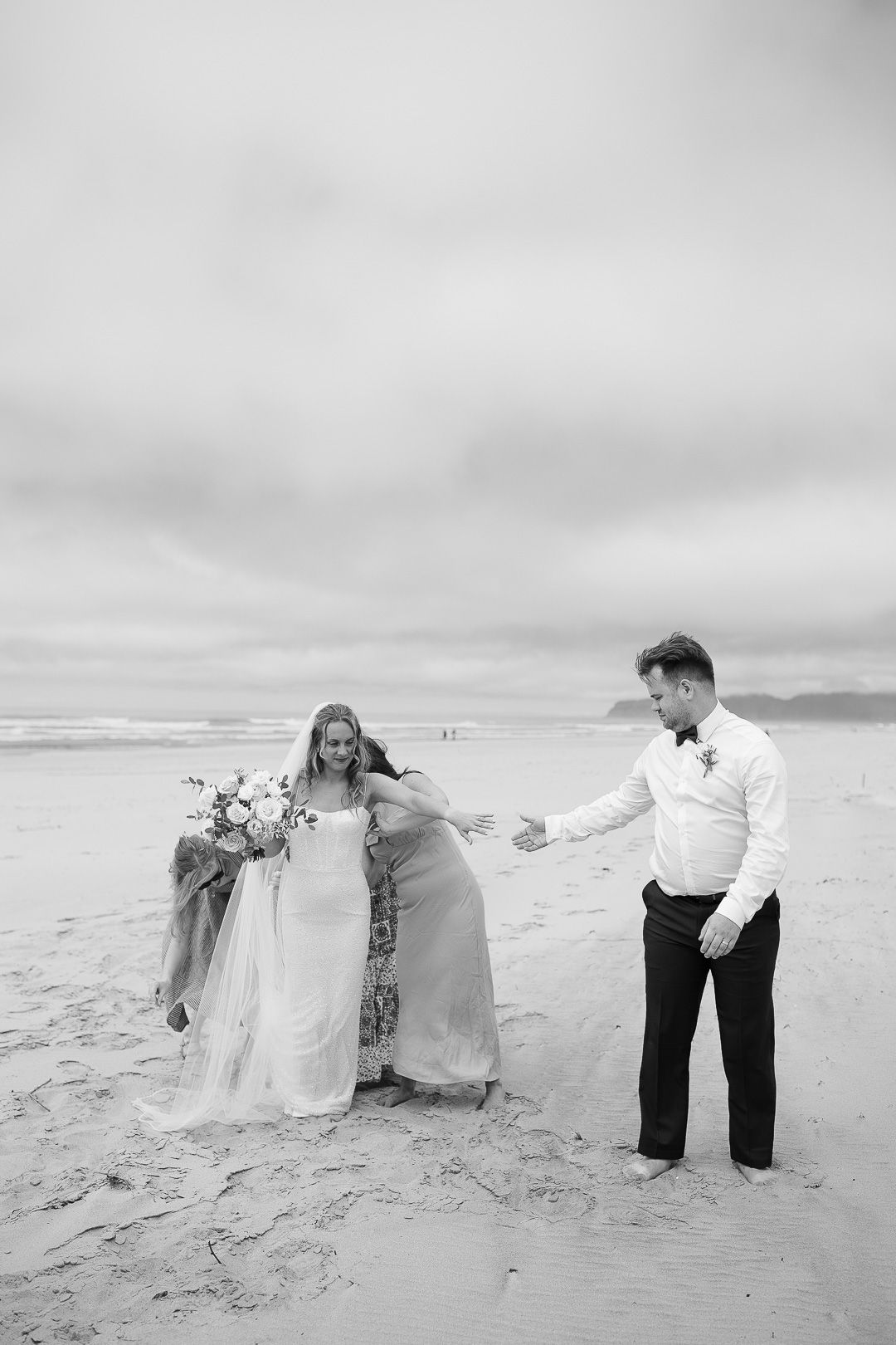 A romantic black and white photo sequence of a couple on a beach showing tender moments in the sand.