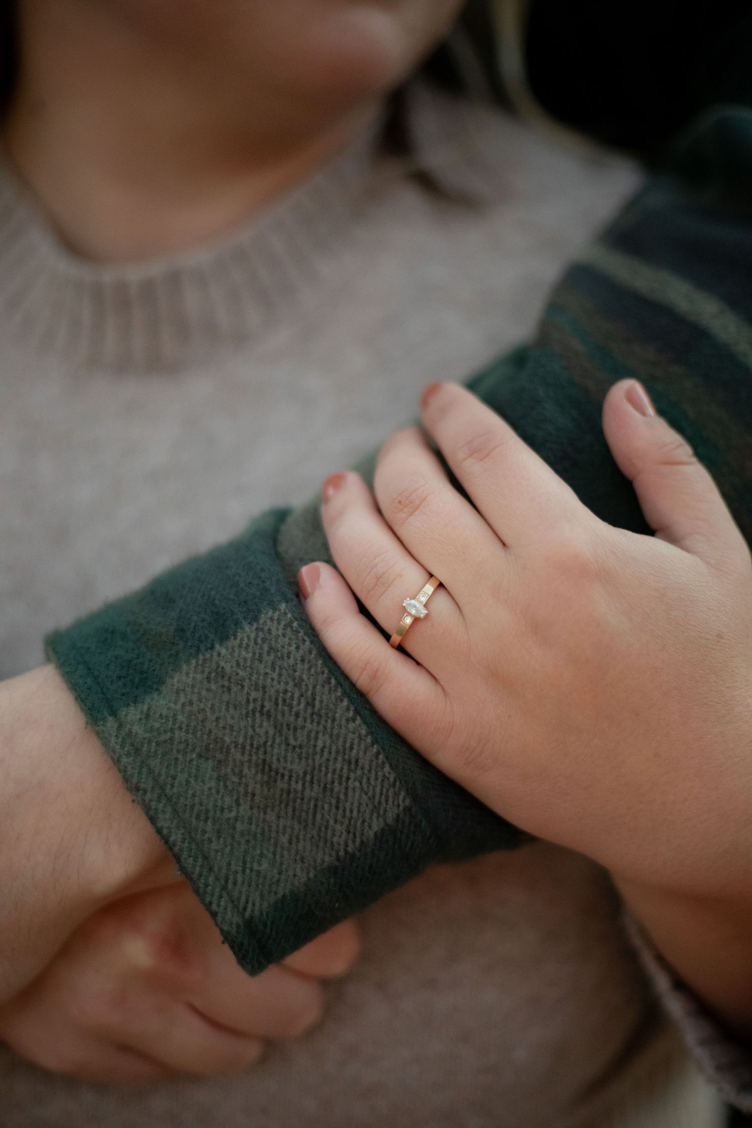 Close-up of hands with engagement ring on Oregons Coast  - Adrianna Elizabeth Photography.