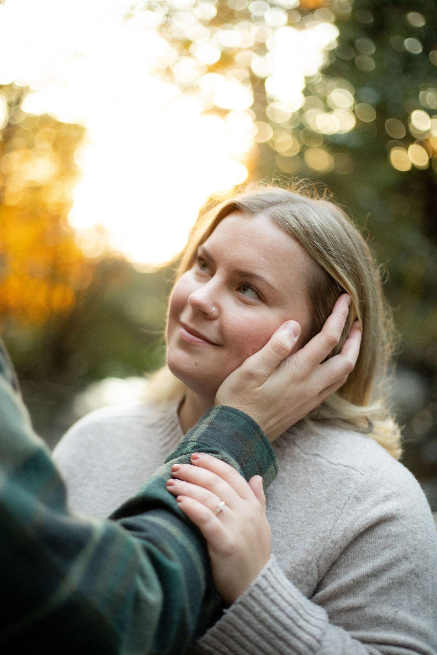 Engagement session tender moment captured in warm sunset light with gentle embrace on 35mm film.