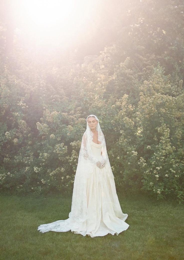 Ethereal bridal portrait series in a sunlit garden with flowing white gown and veil creating dreamy atmosphere.