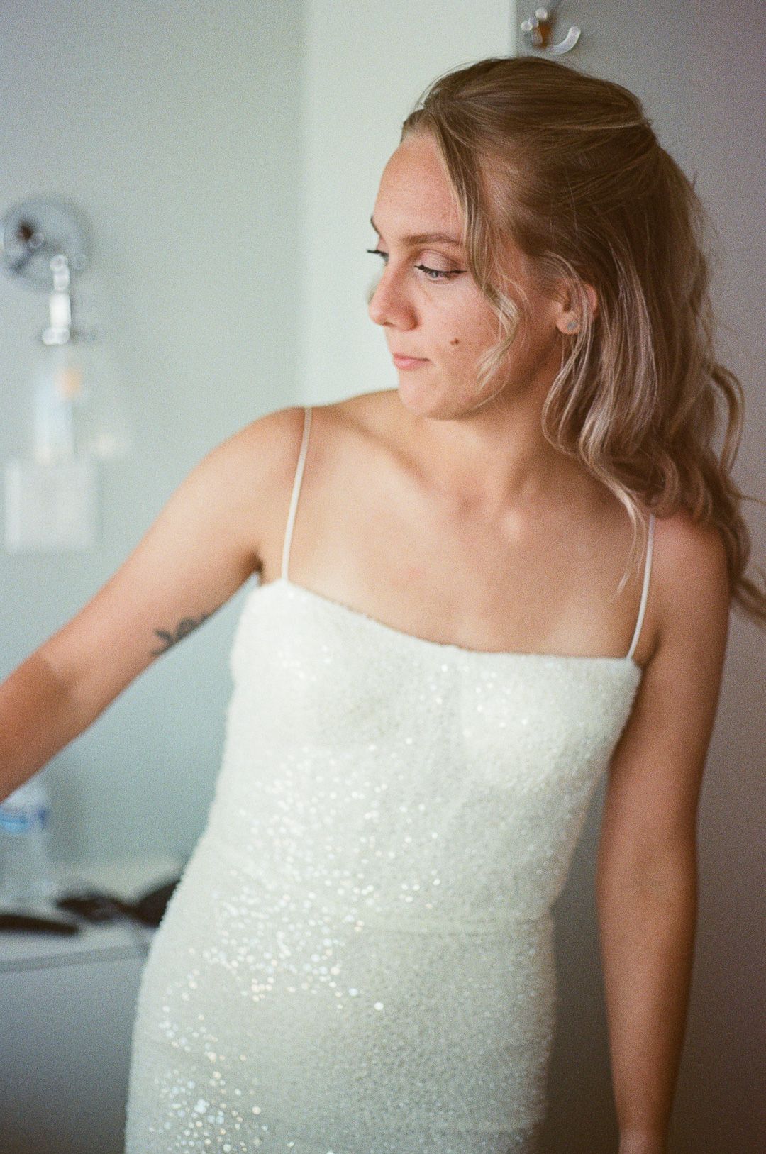 A series of photos showing a person in a white sequined dress posing gracefully against a light background.