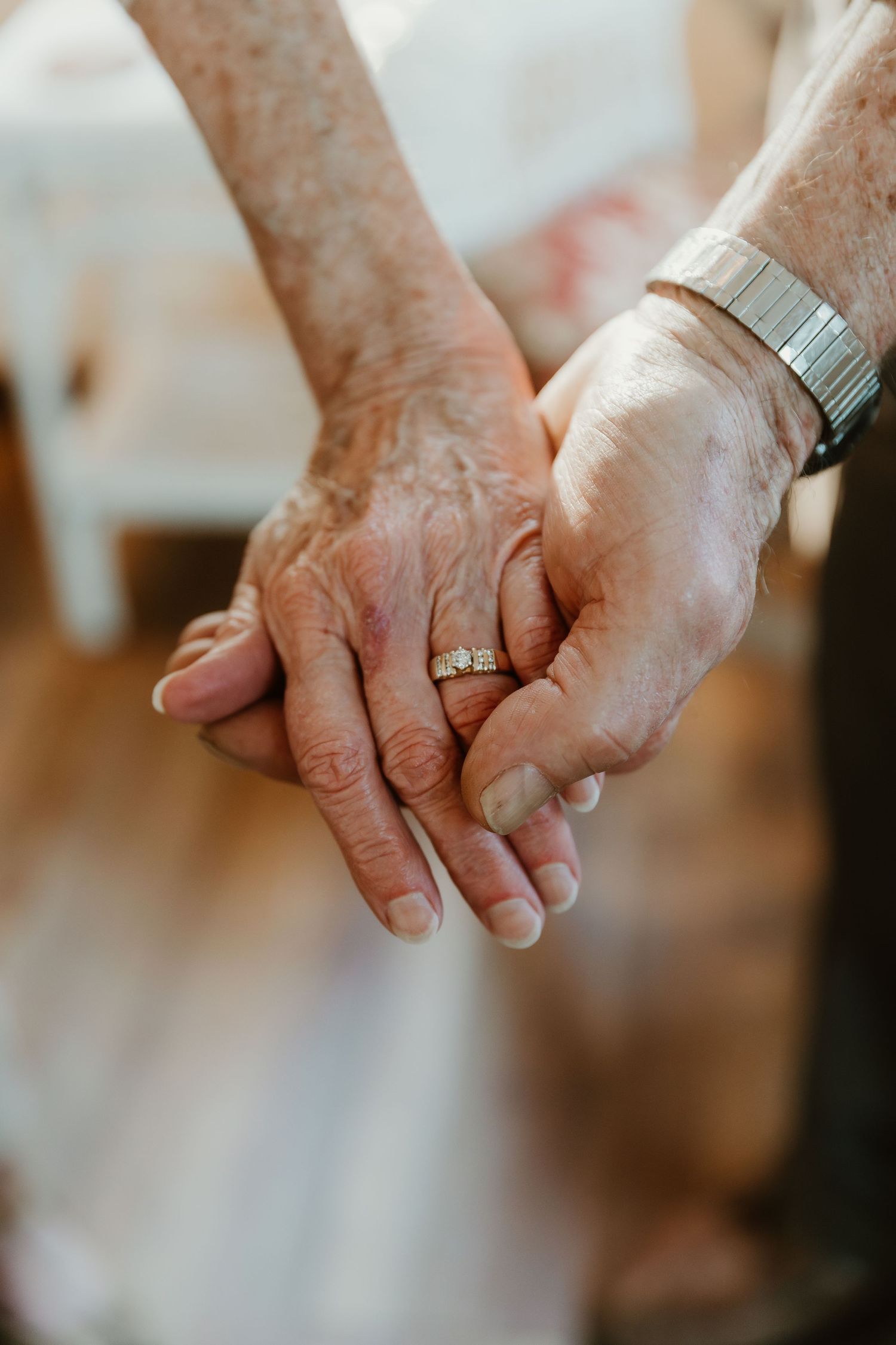 couple showing their wedding ring at 50th anniversary party while posing for central illinois wedding photographer