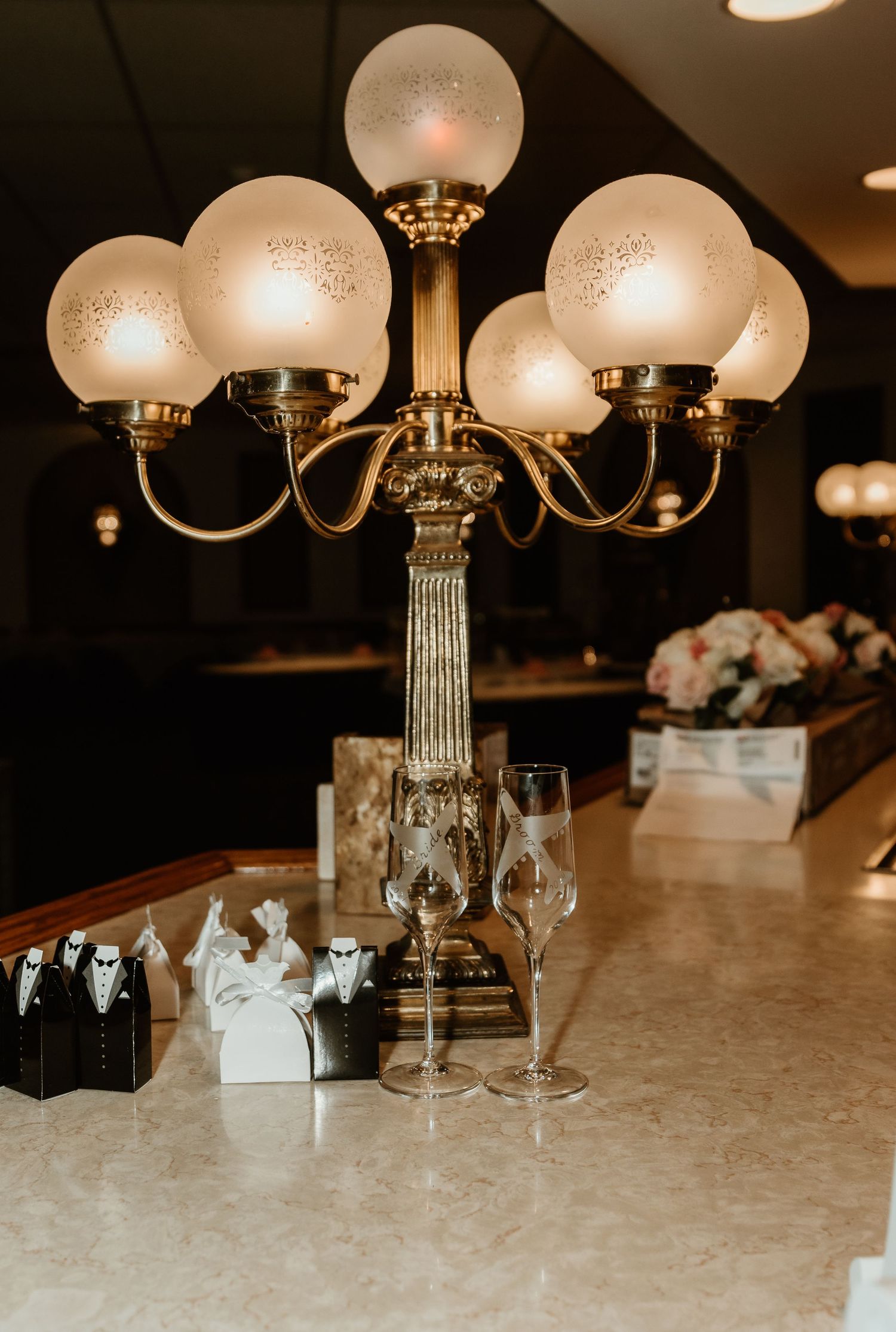 Vintage-style wedding decorations featuring antique light fixture and wedding goodies, creating a timeless and romantic ambiance