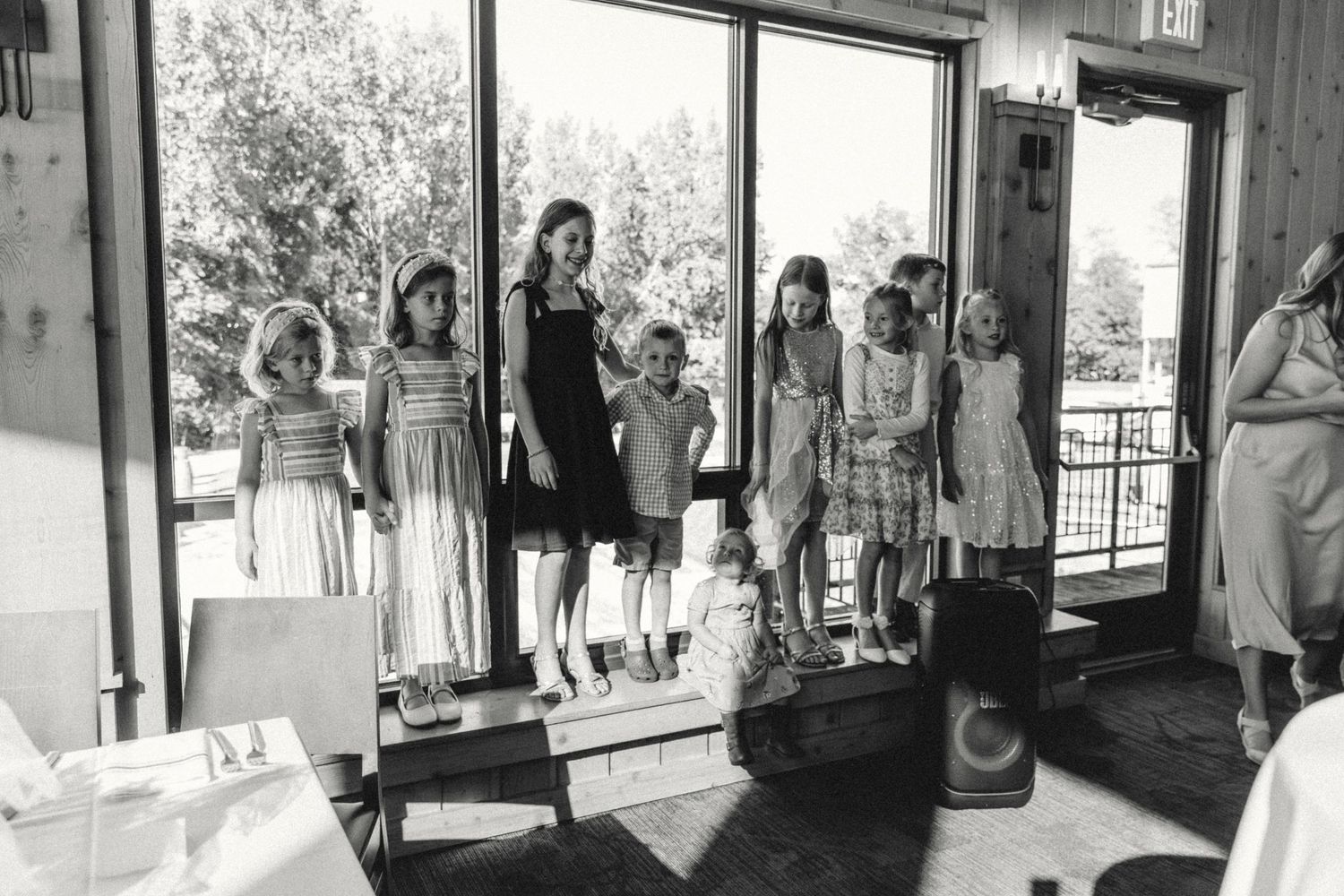 Kids line up for a photo during a wedding reception captured by michigan wedding photographer