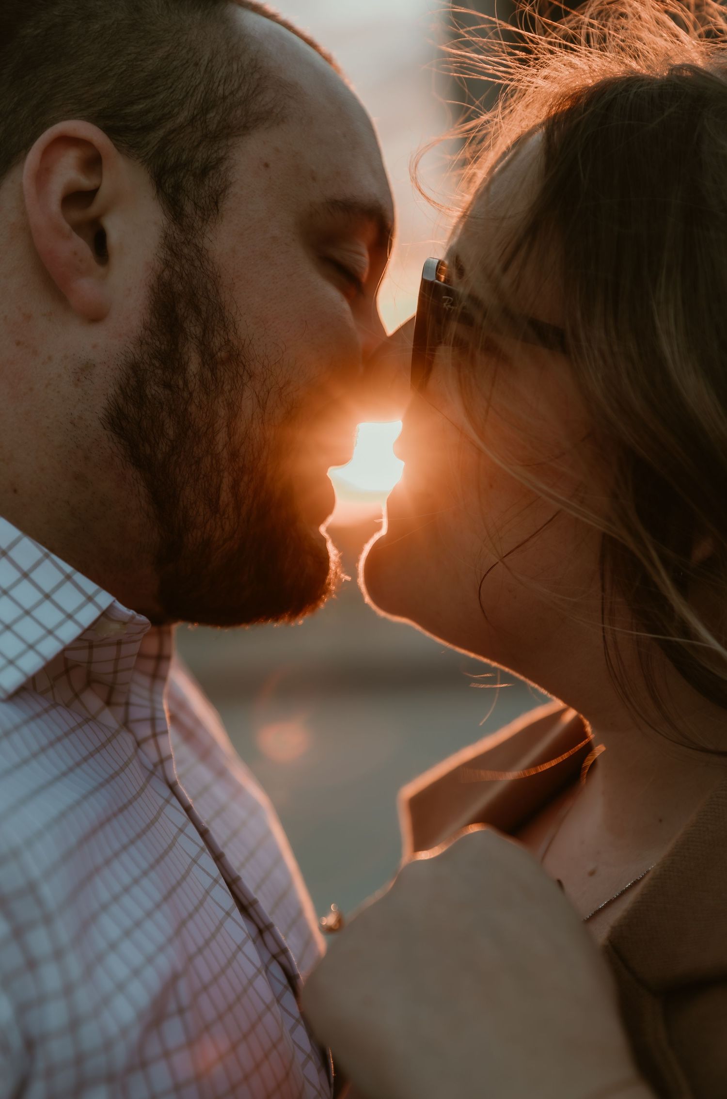 Future bride & groom share a kiss on a rooftop in Uptown Normal,IL during their engagement session captured by central illinois photographer