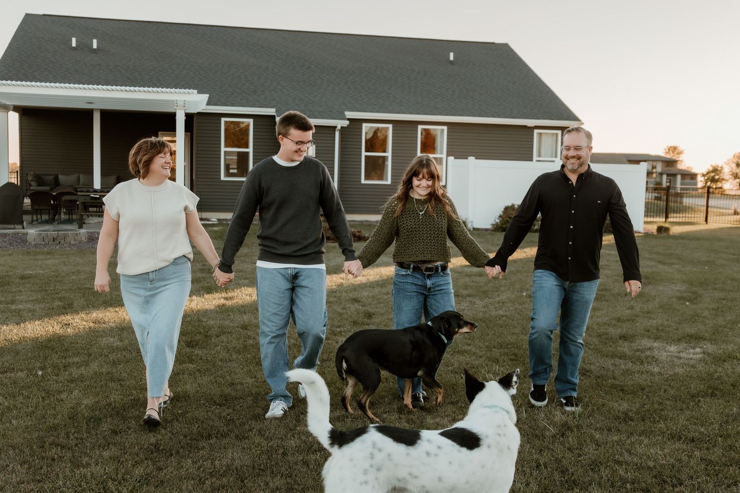 Central Illinois Photographer captures Family walking with their dogs at their new home during a family photo session