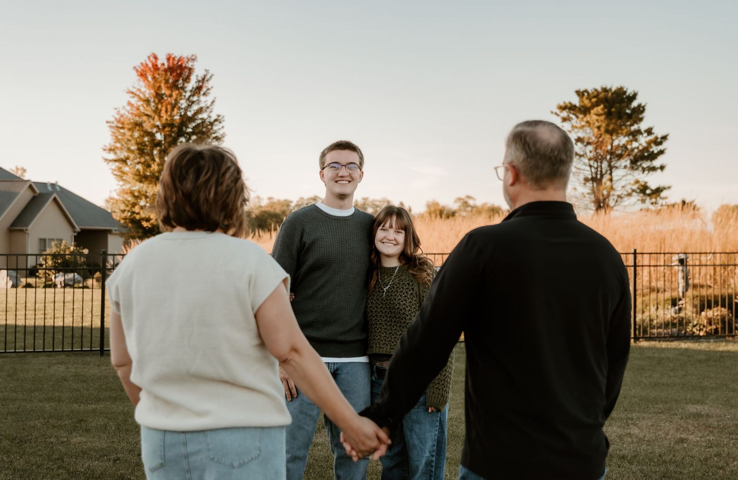 Mom and dad gaze at their creation while holding hands during their family photo session captured by central il photographer