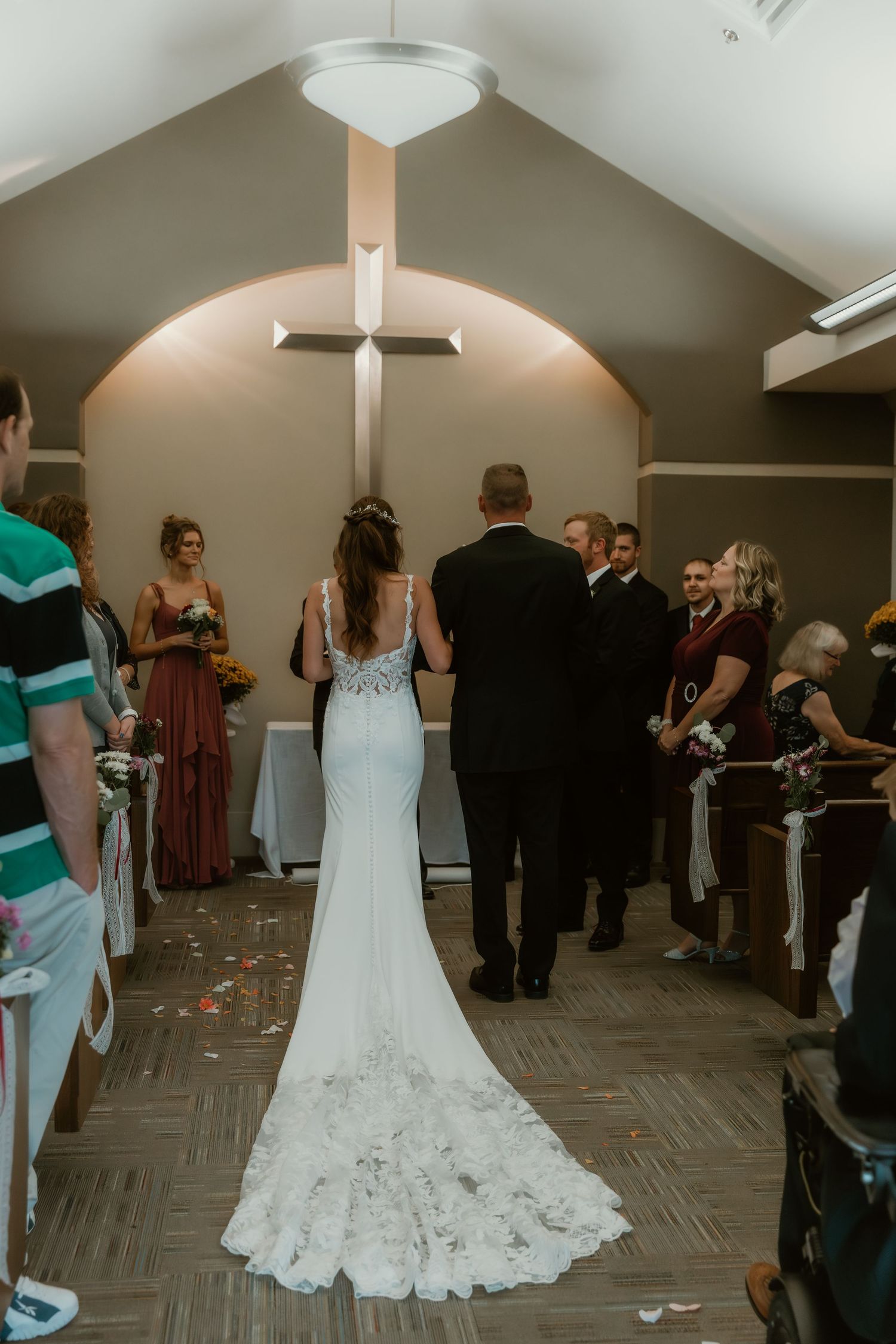 Dad walks his daughter down the aisle in a chapel and god centered wedding ceremony