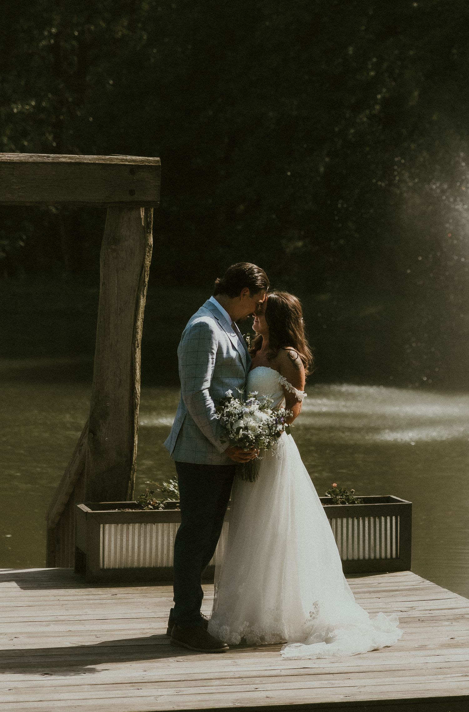 Sehl Photography Bloomington IL photographer captures an intimate dockside moment—soft light, lake stillness, and emotional connection.