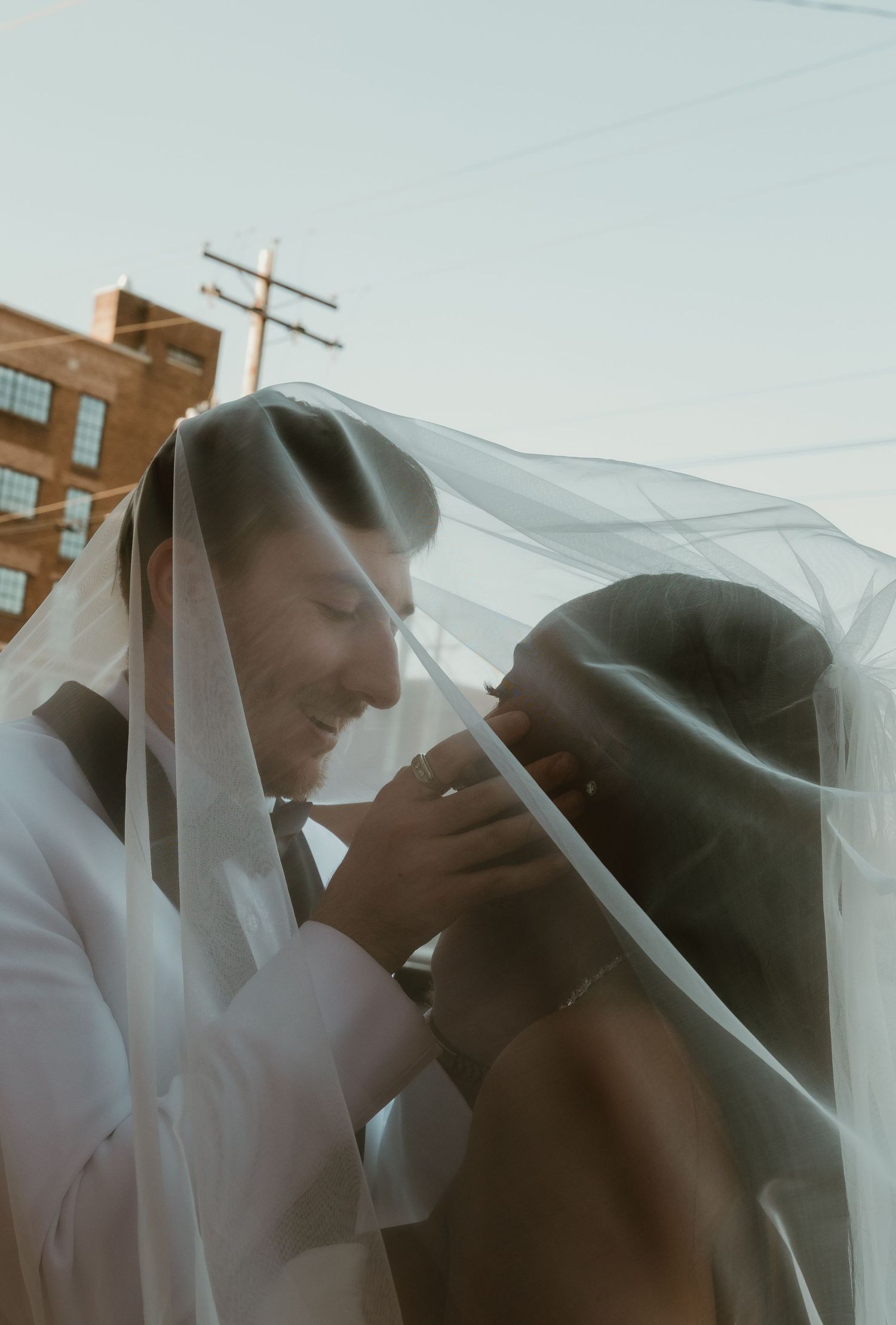 Bride and Groom take an intimate moment under the veil during wedding portraits with central illinois wedding photographer