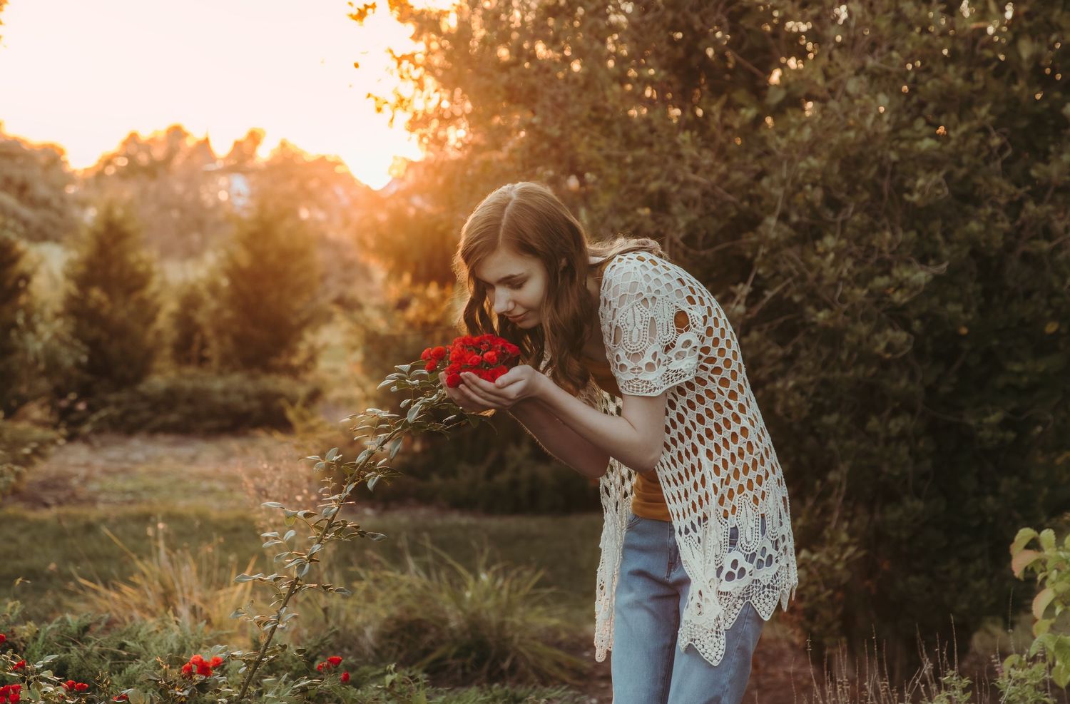 High school senior smells flowers during a senior session with Central Illinois Photographer