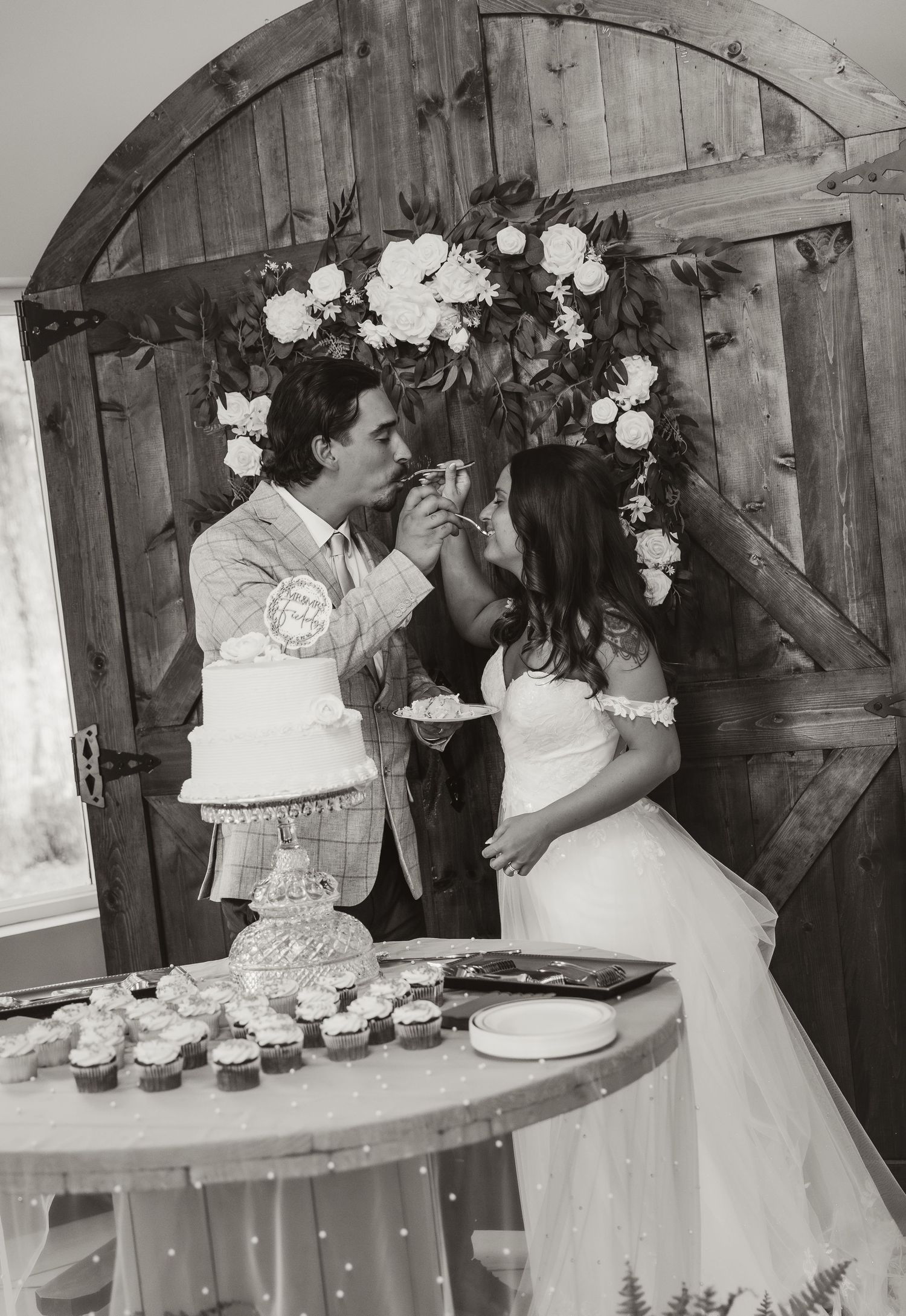 Bride and groom feed eachother cake during cake cutting at dragonfly wedding venue captured by central illinois photographer