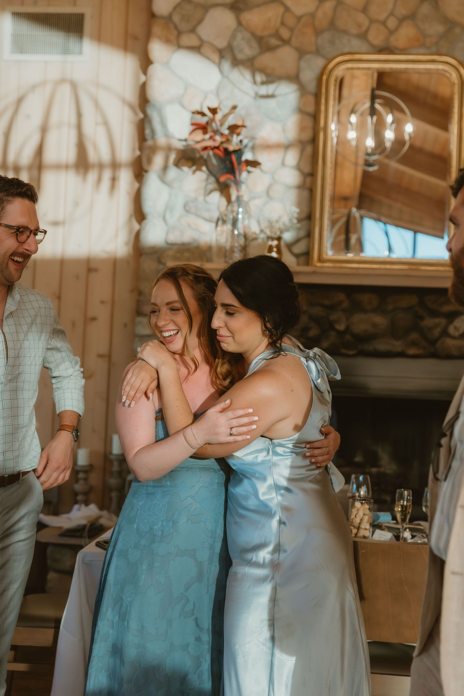 Bride's best friends hugging each other during a wedding reception