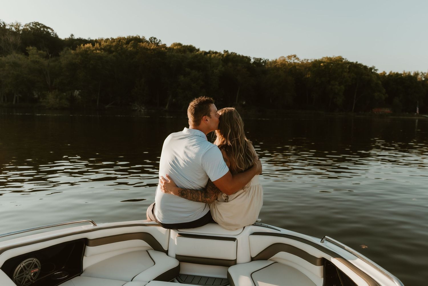 Future mr and mrs shares an intimate moment during their engagement session on their boat captured by illinois wedding photographer