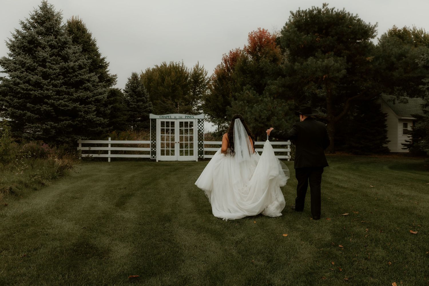 Bride and Groom walking to the next photo spot during wedding party portraits captured by central illinois elopement photographer
