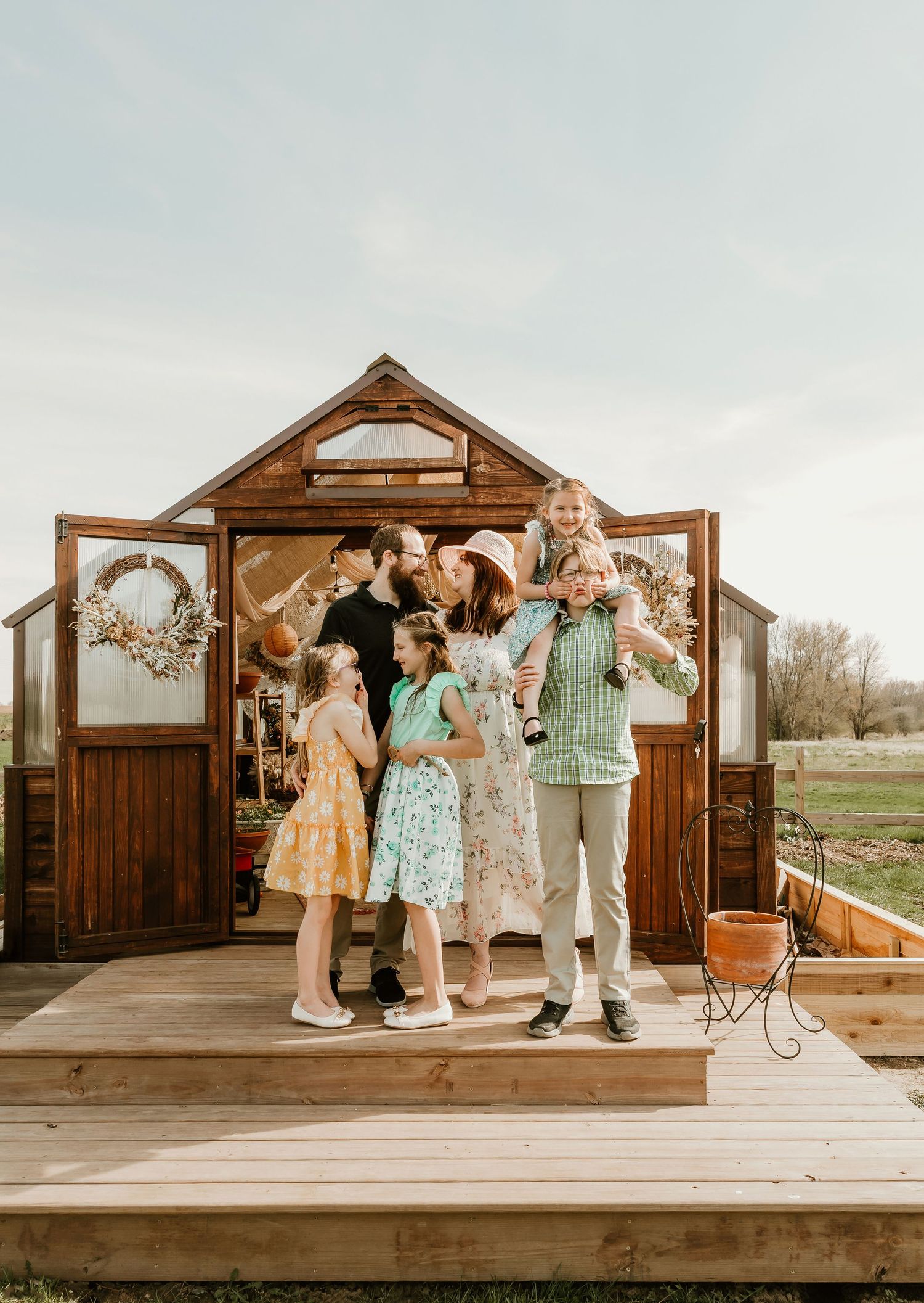 Family bonds over silly faces and smile while being captured by central il photographer during a family photo session