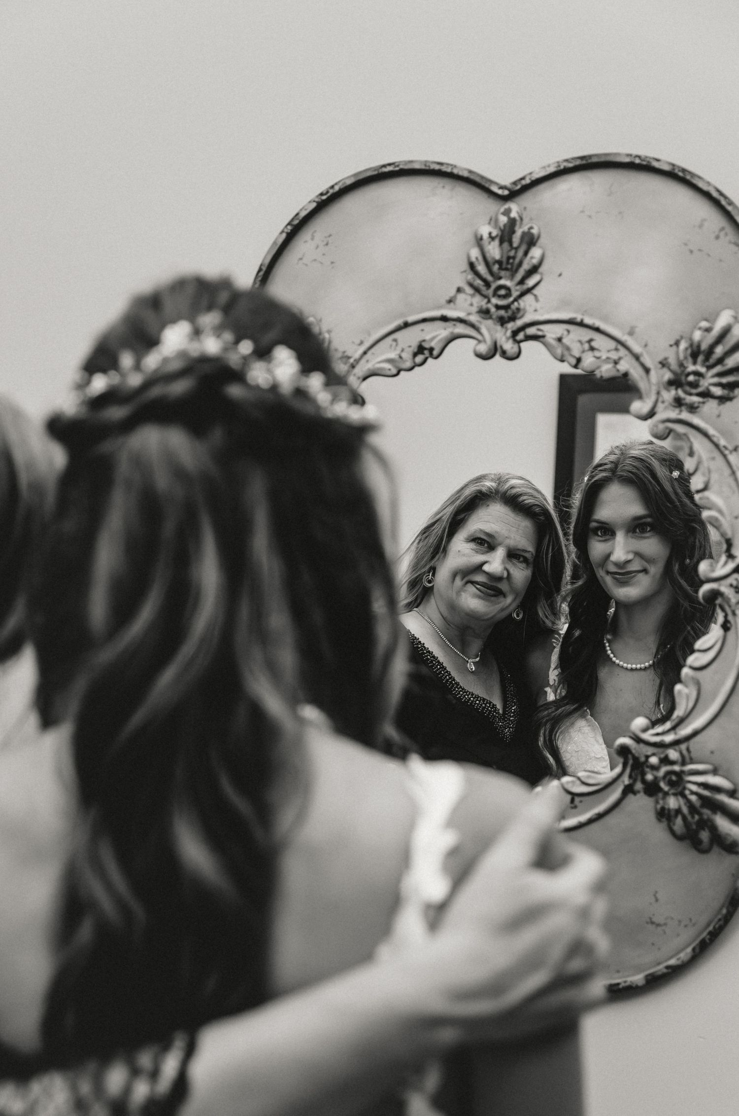 Bride and her mom share a sweet moment with one another before the wedding ceremony