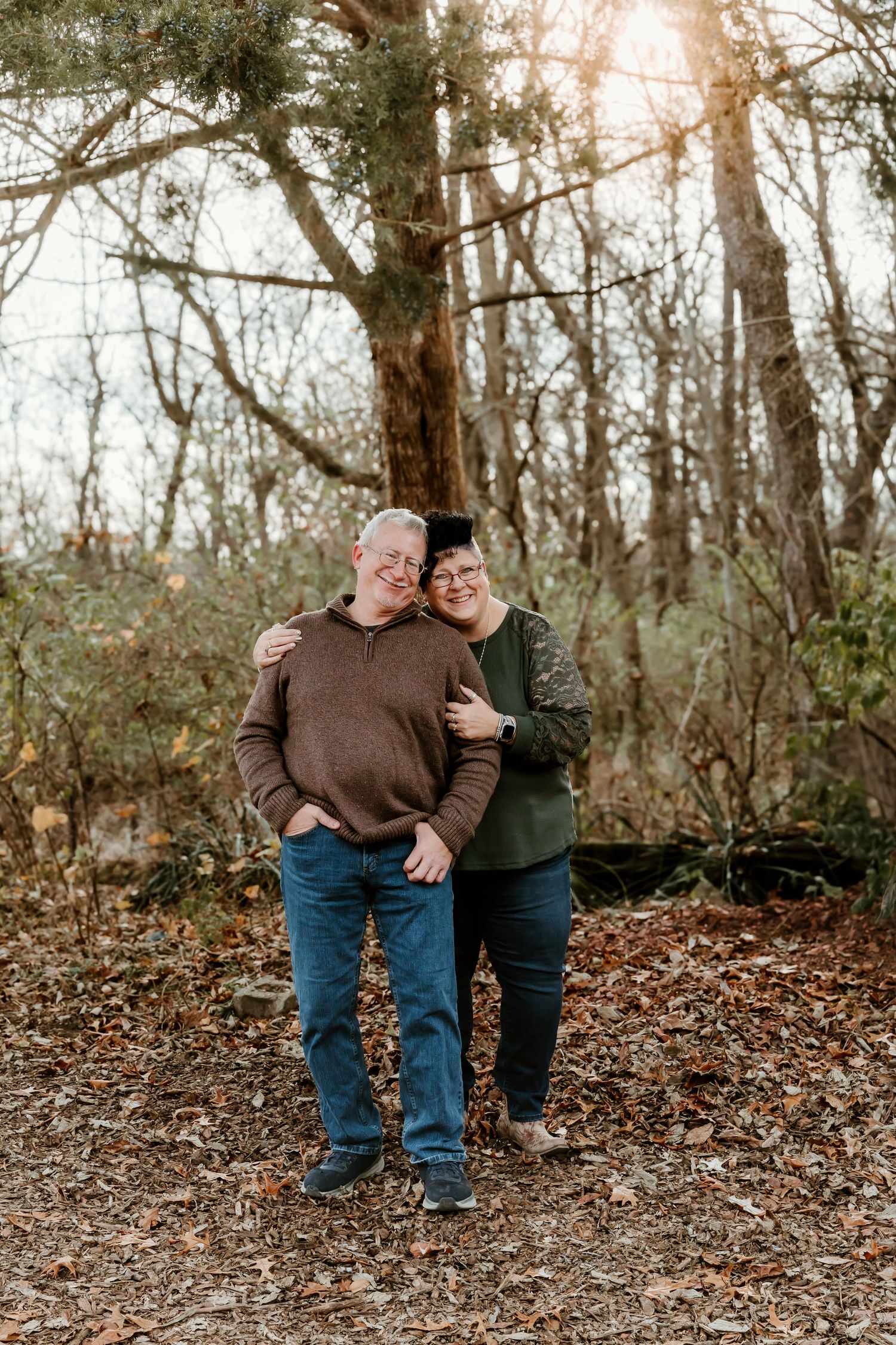 Wife hugging husband from behind for a family photo session