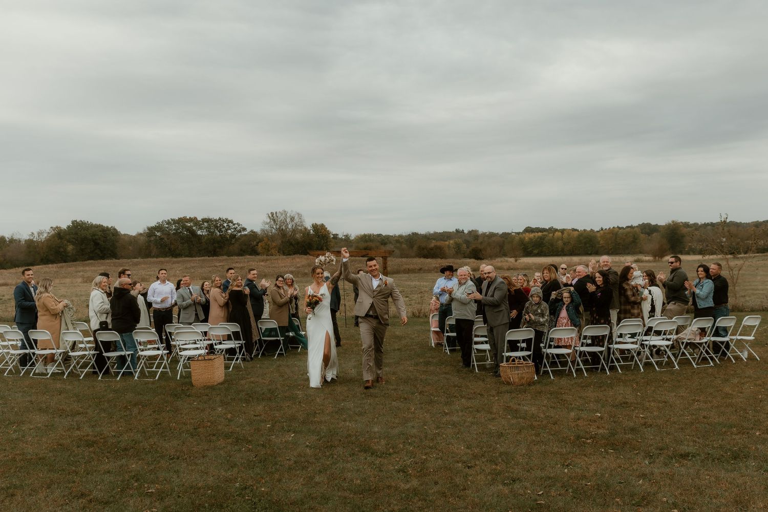 Bride and Groom walk away from their ceremony in all smiles after being married