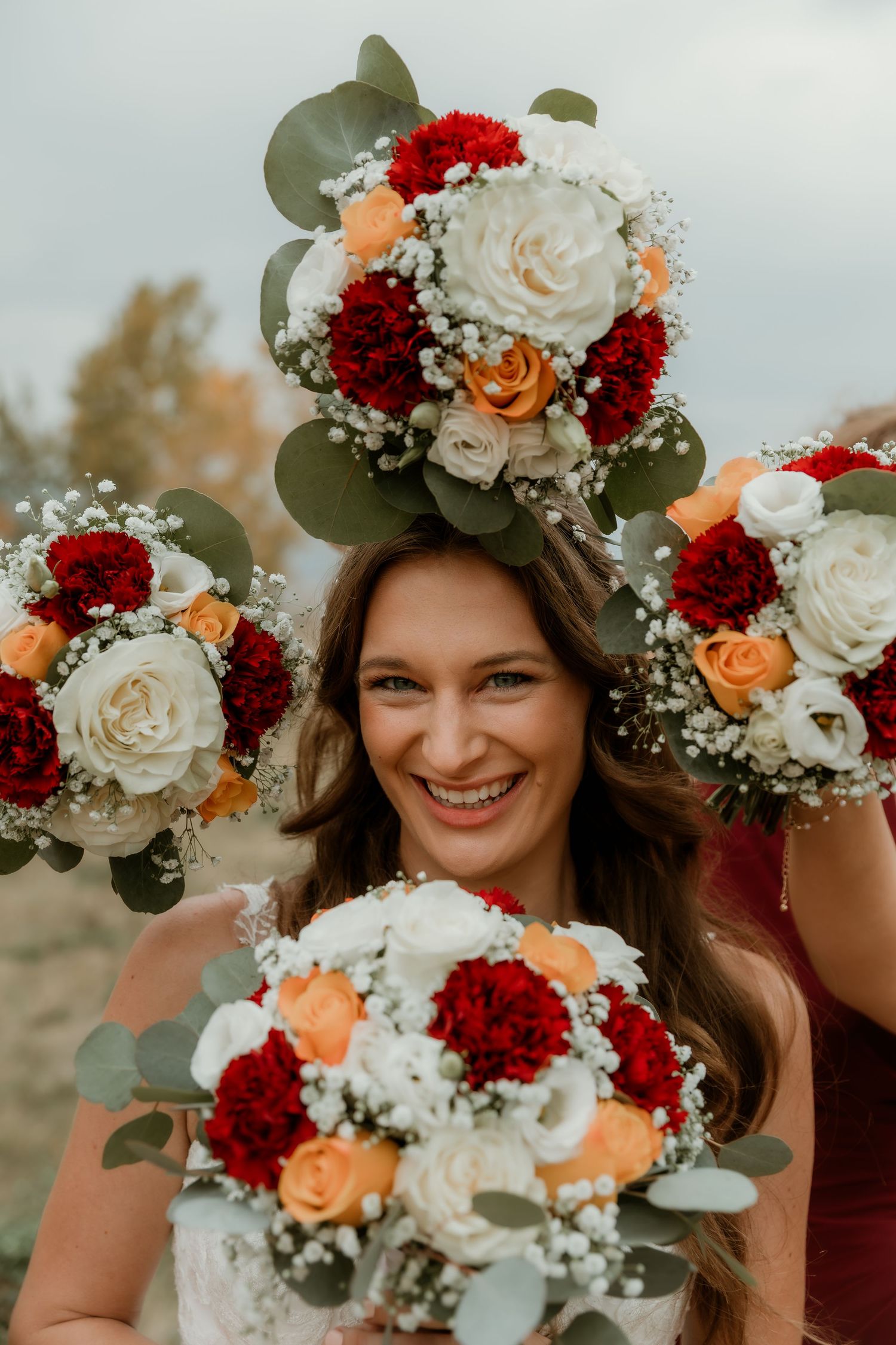 Bride is bordered with wedding flower bouquets for an individual bridal portrait during her wedding day