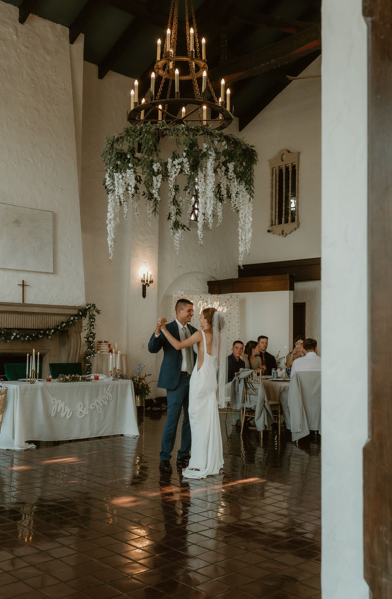 Bride & Groom share their first dance in front of their loved ones during their wedding reception captured by illinois wedding photographer