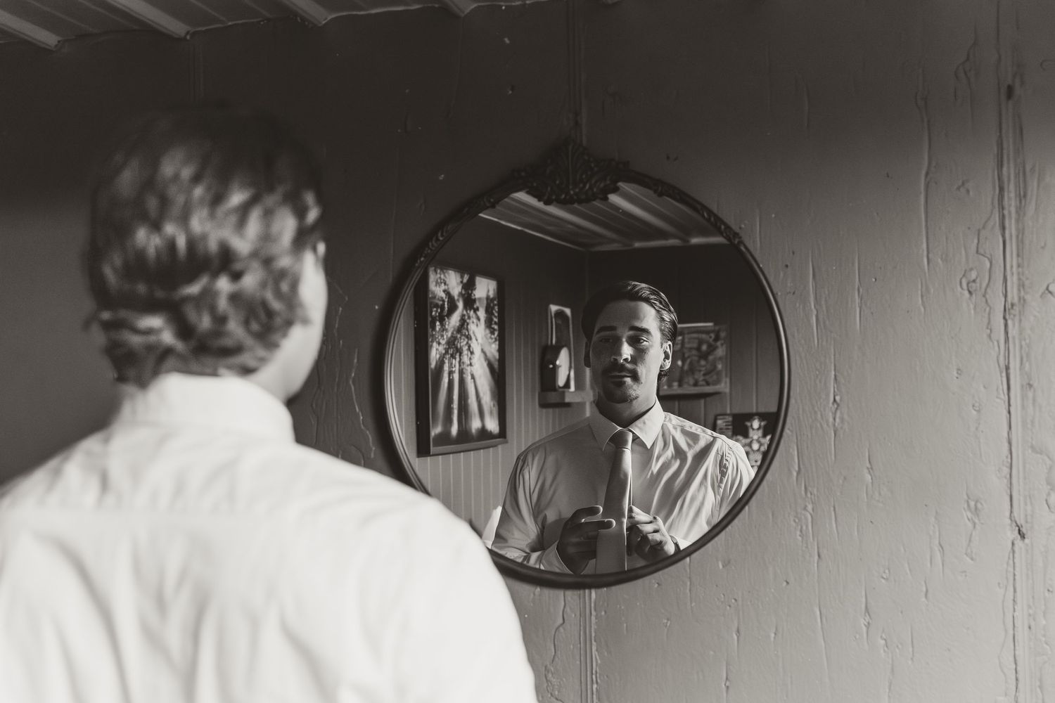 Groom getting ready for wedding in grooms room at dragonfly wedding venue captured by illinois wedding photographer