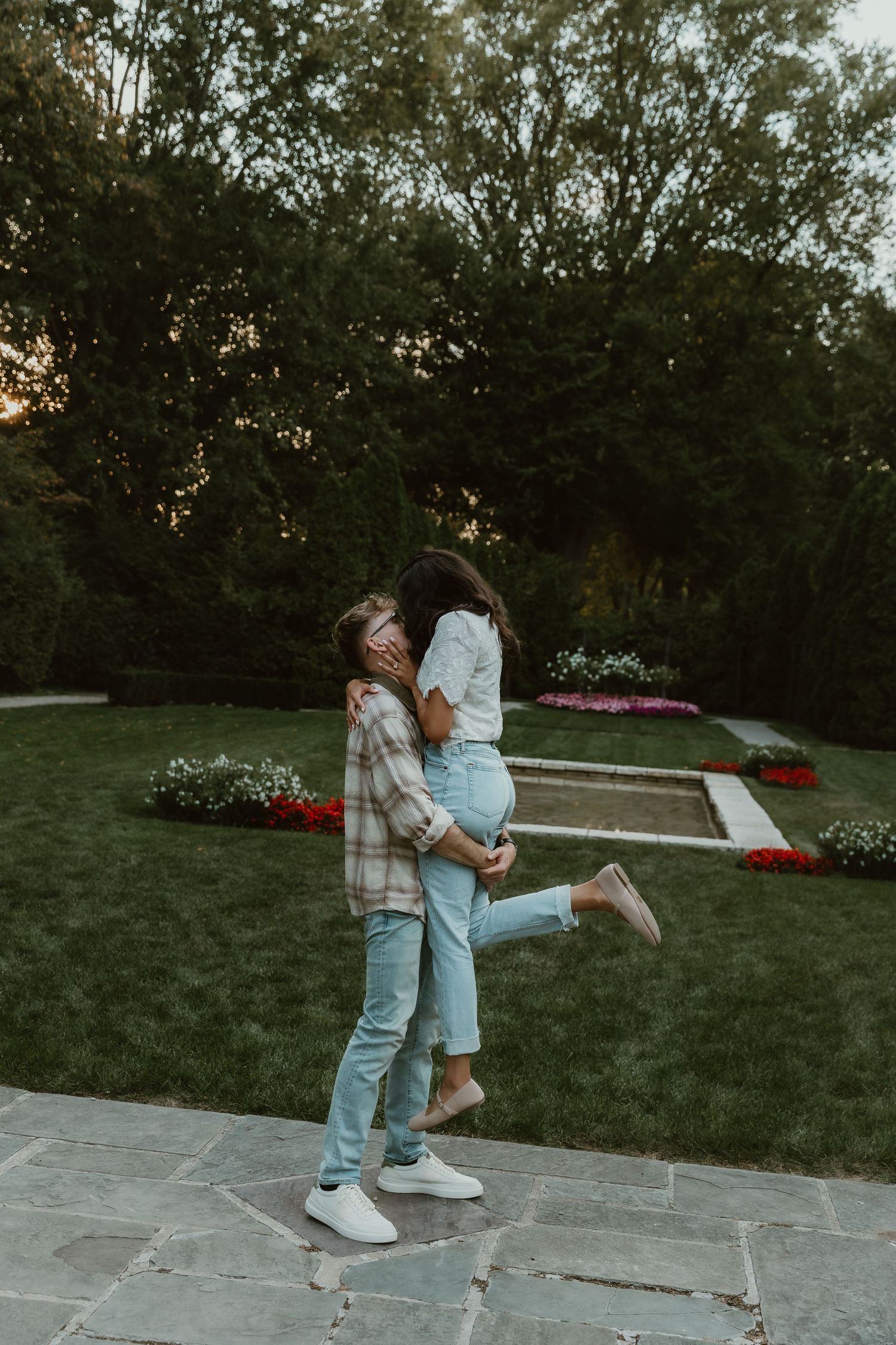 Groom picks up bride, to sway and kiss her, during their engagement session with illinois wedding photographer